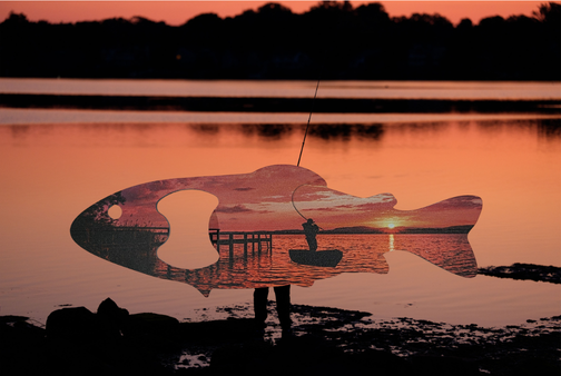 Sunset lake UV printed fish bottle opener floating against a glowing evening water background..png