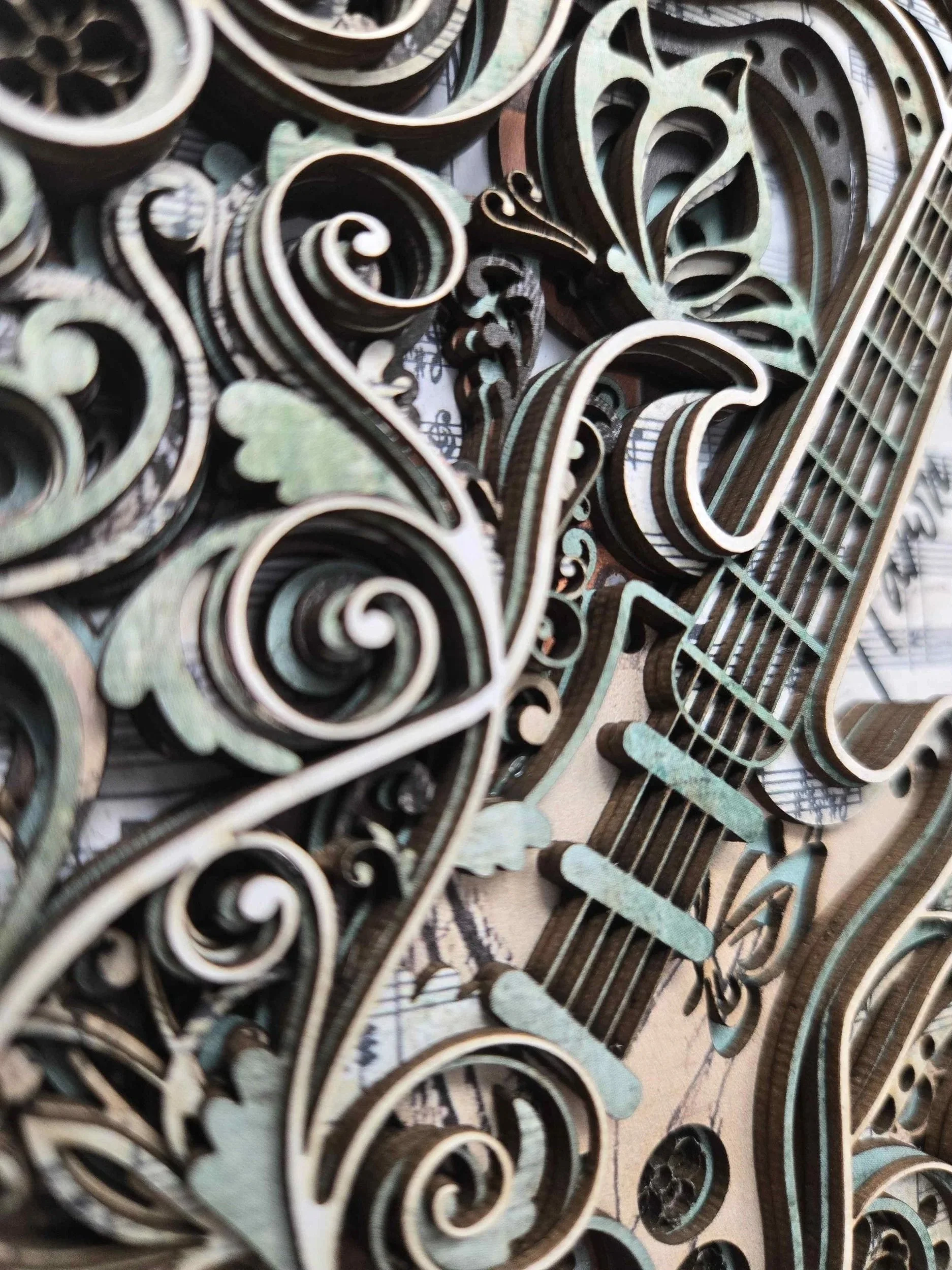 macro shot showcasing the sharp shadows and intricate filigree of the 8-layer mount board construction, emphasizing the artisan quality