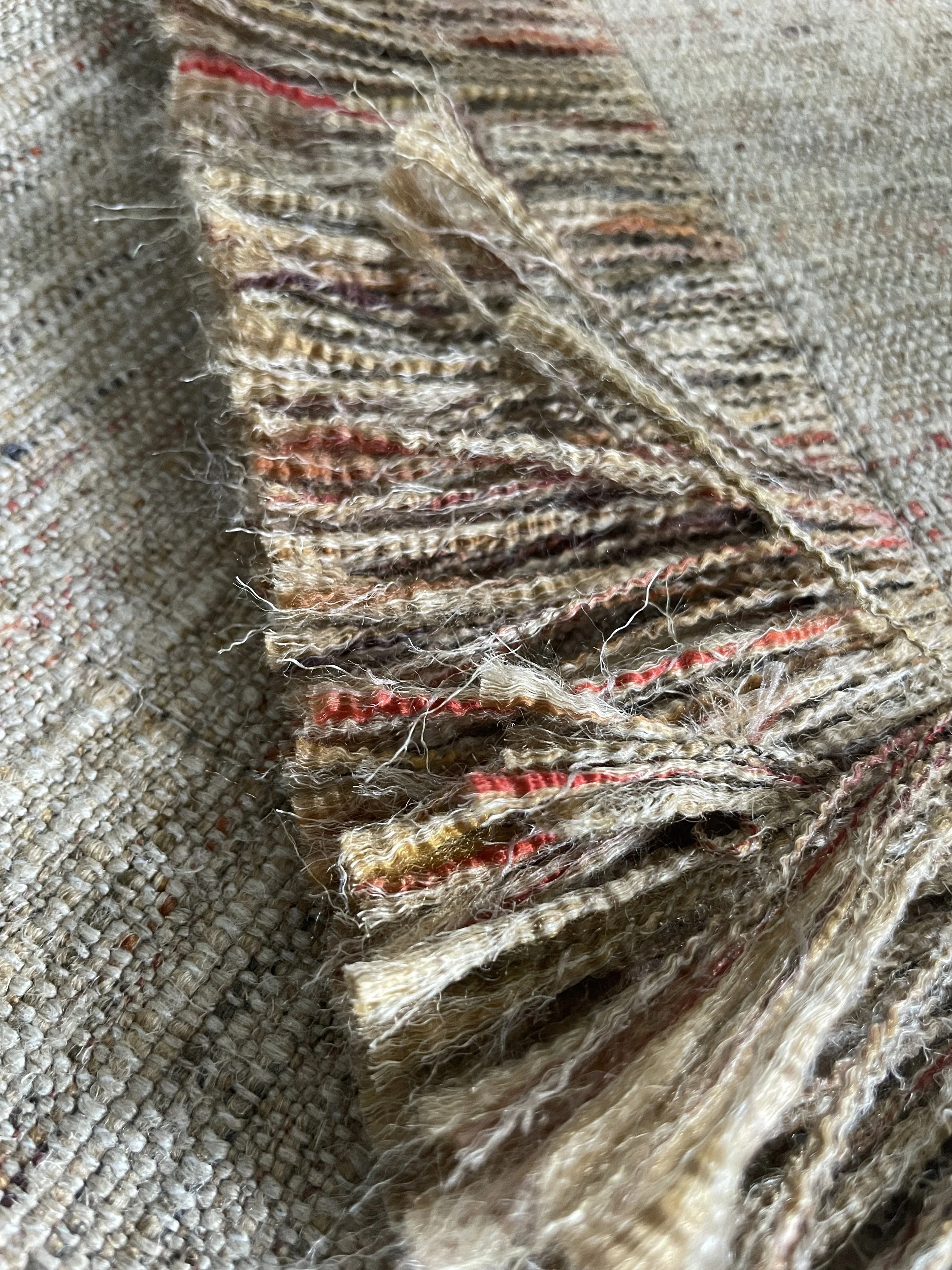 An image of a cushion cover with fringes.