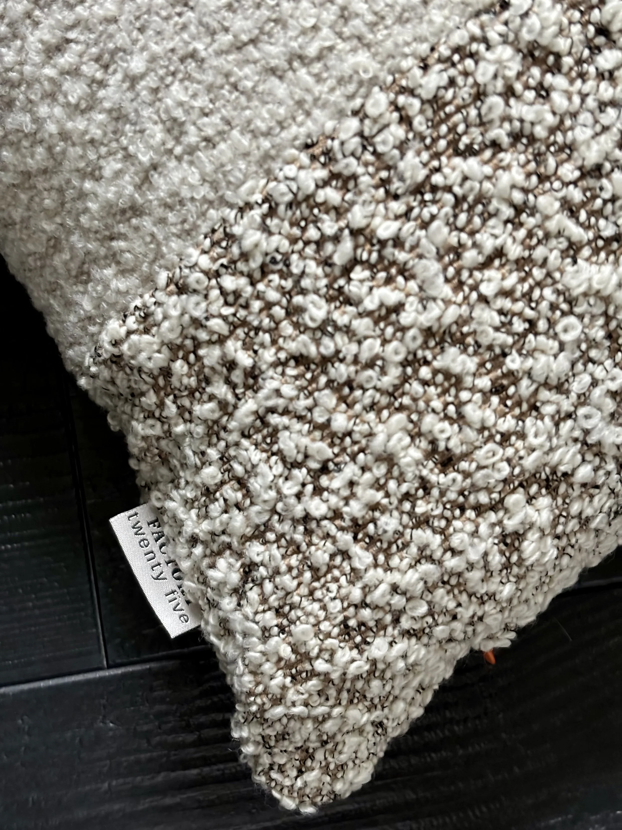 An image of a cushion cover made from a bouclé fabric and linen wool fabric