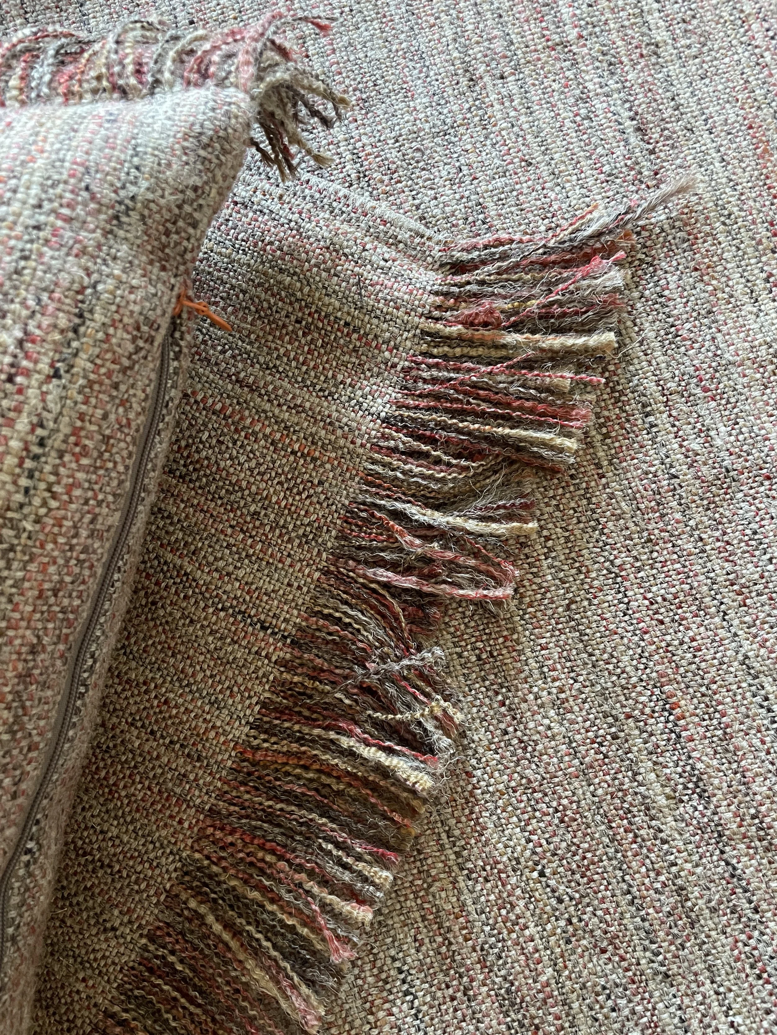 An image of a cushion cover with fringe