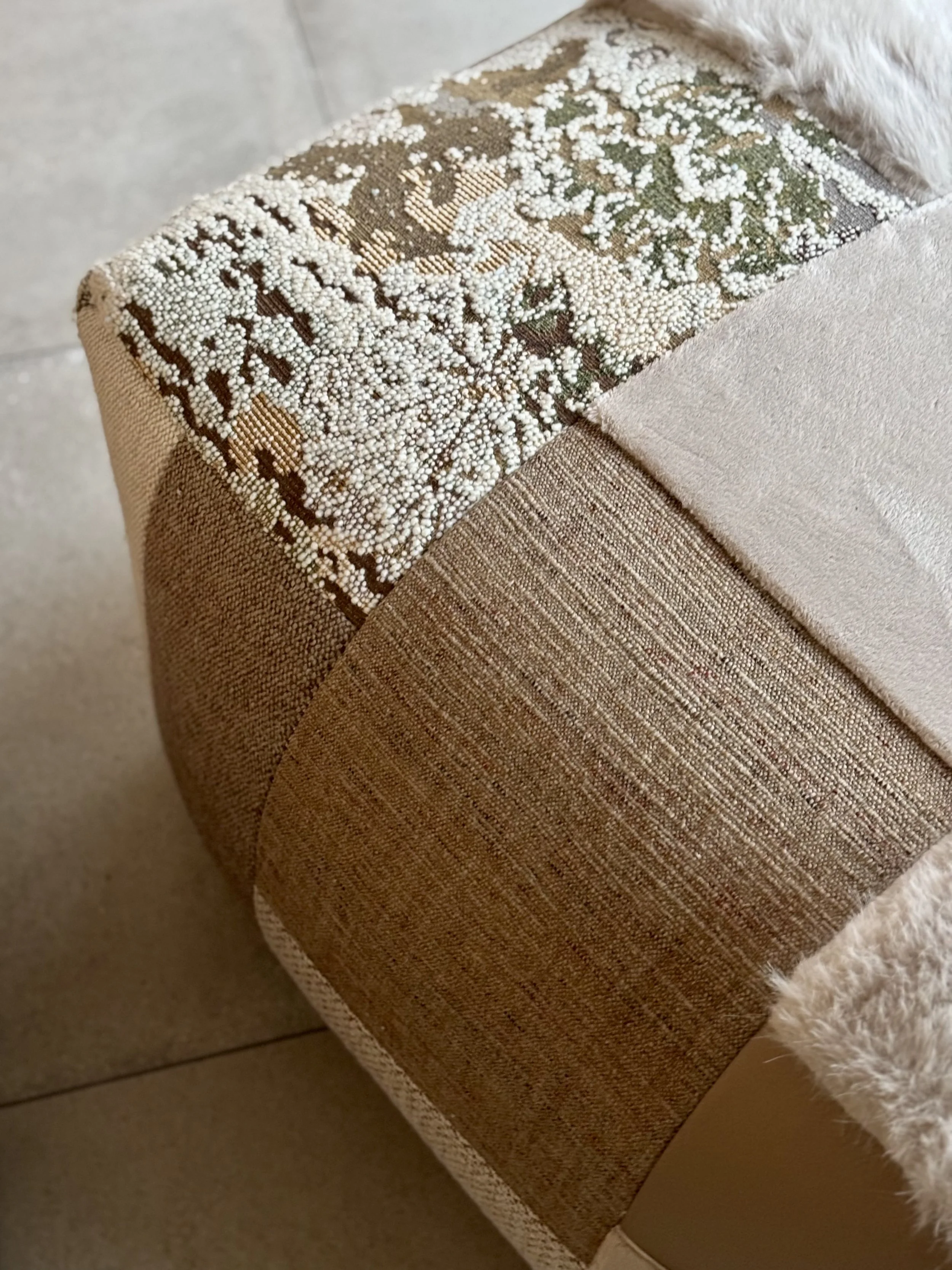 An image of a cushion cover made from a rich jacquard fabric with contrasting piping