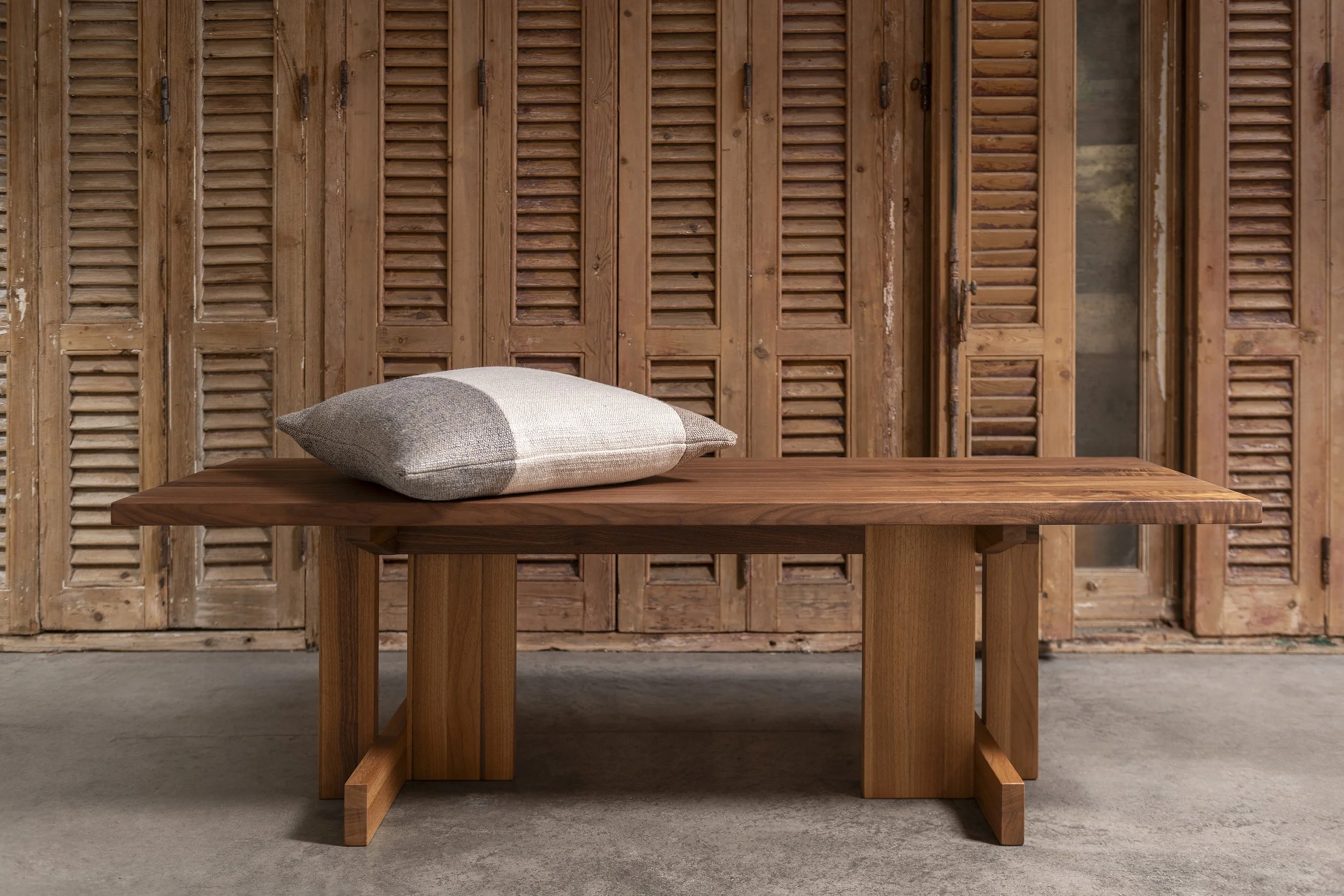 An image of a bench with intricate feet made from American walnut.