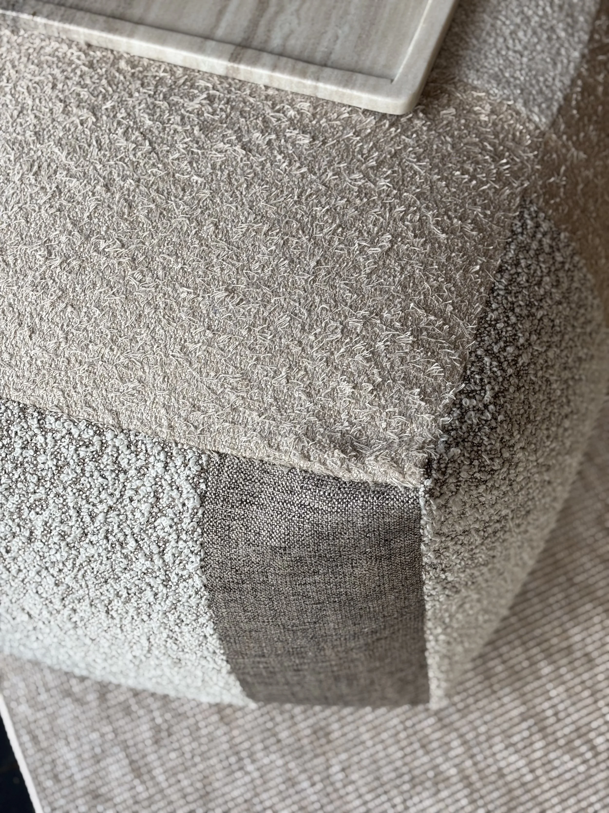 a picture of a handmade rectangular pouf in earth tones 