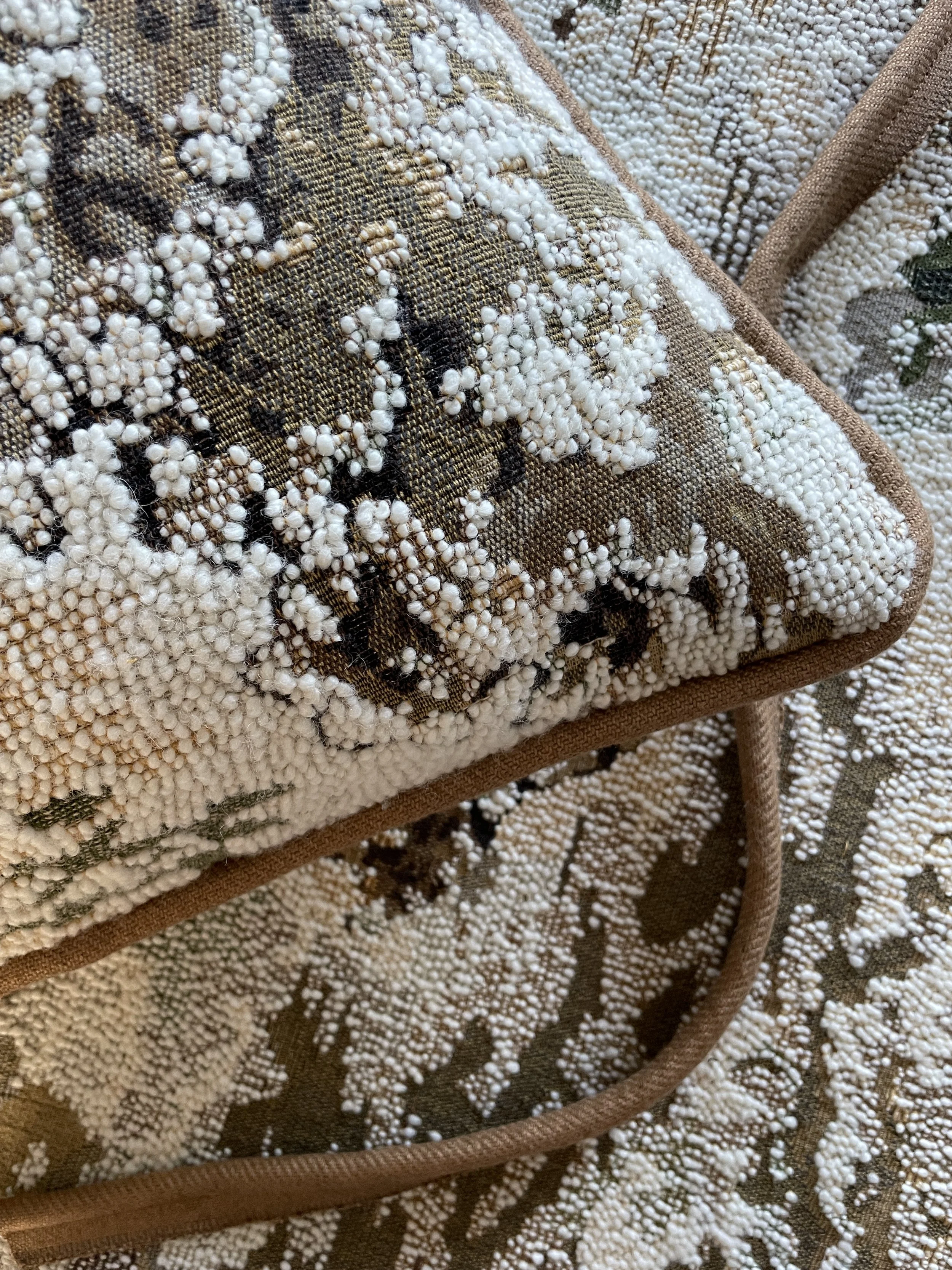 An image of a cushion cover made from a rich jacquard fabric with contrasting piping