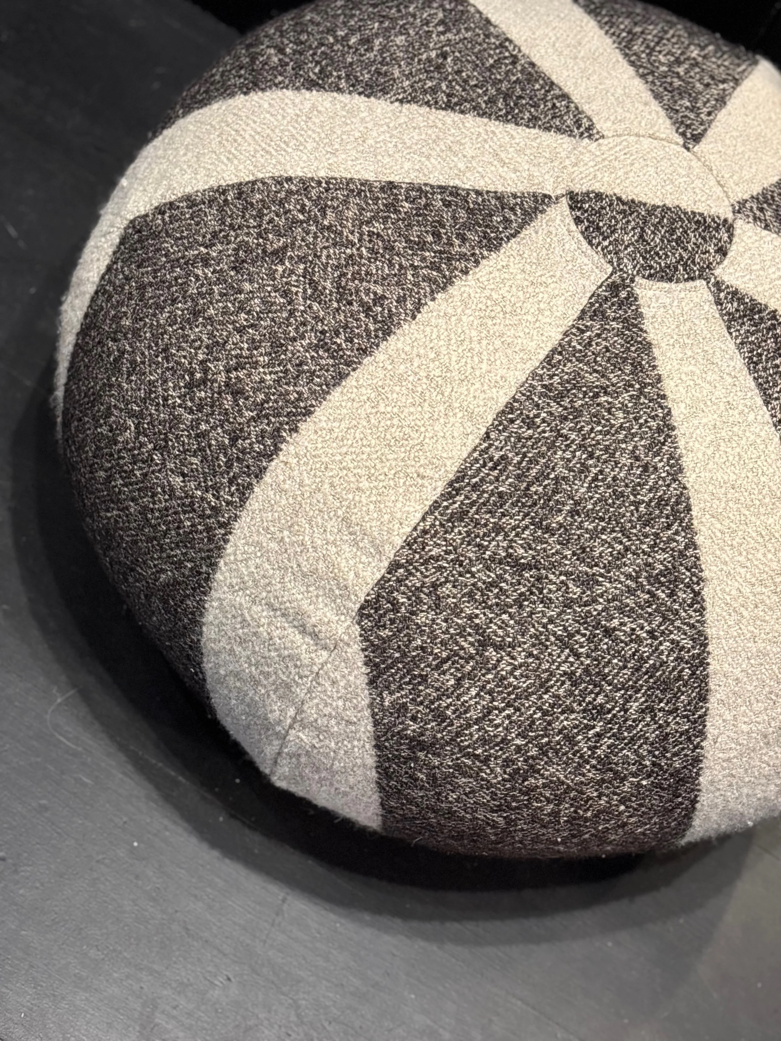 A picture of a handmade round pouf in earth tones  