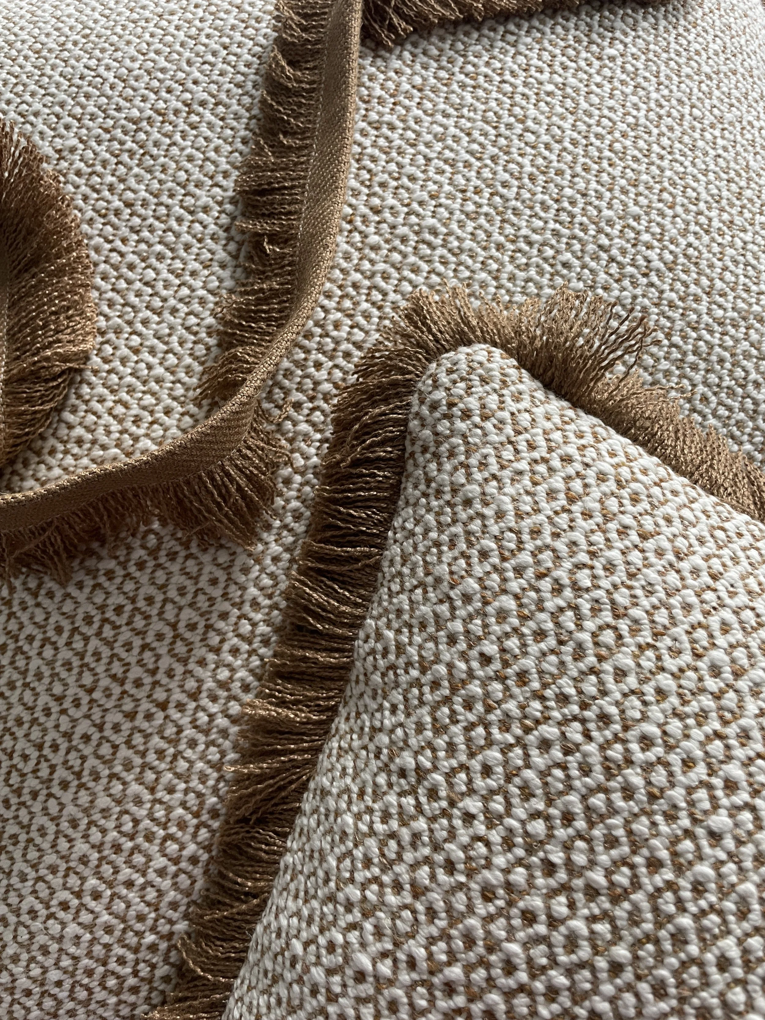 An image of a cushion cover with a fringed piping.