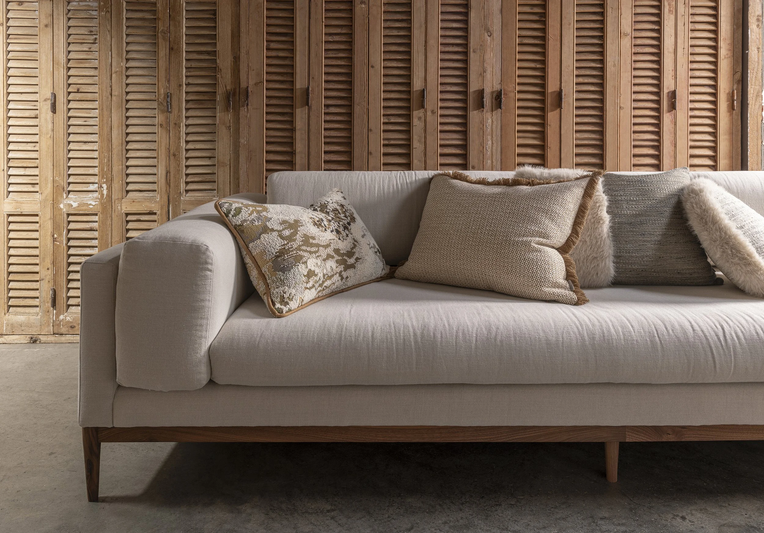 An image of a comfy sofa with lots of cushions.