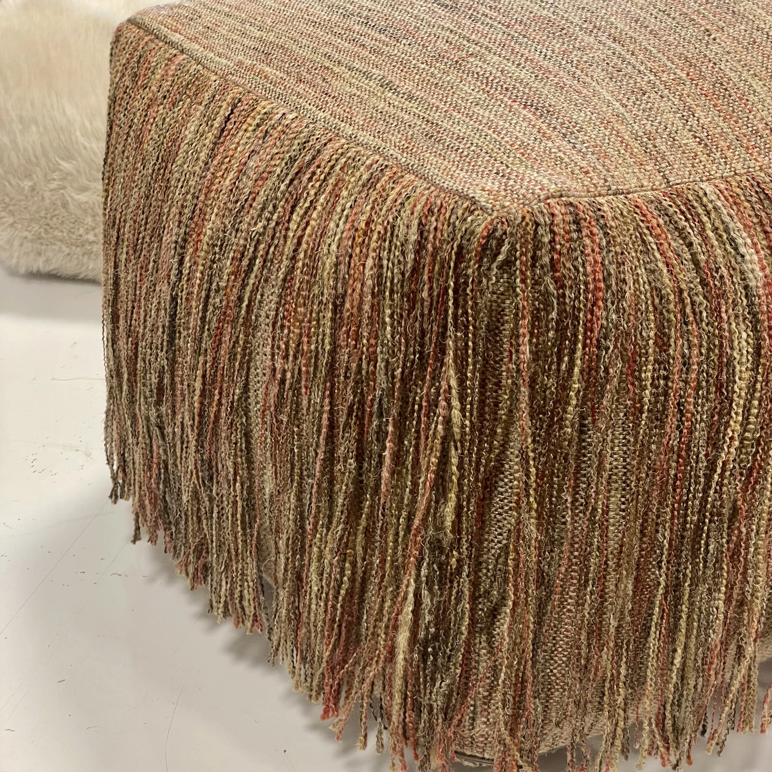 An image of a pouf with long fringes.