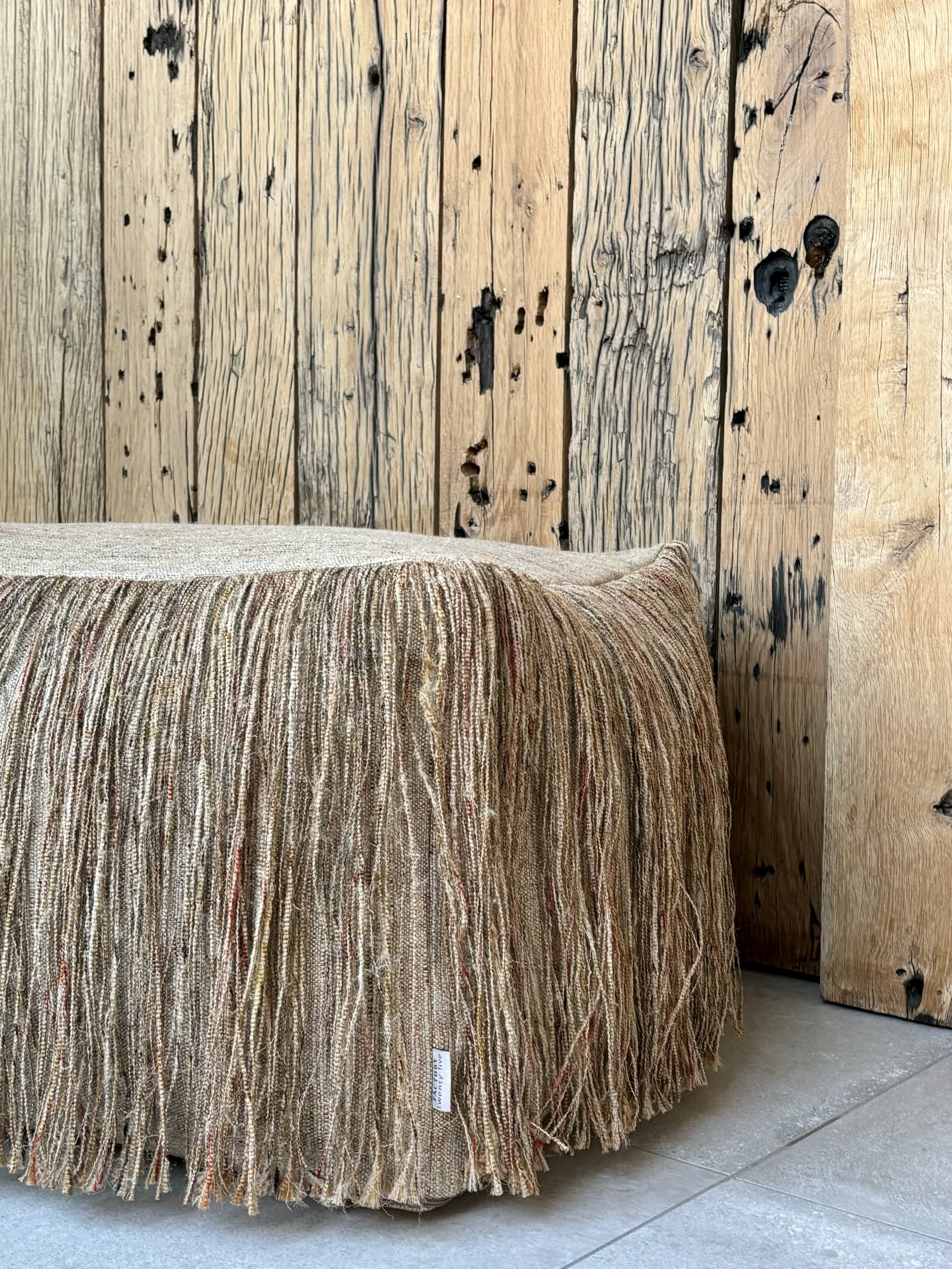 An image of a pouf with fringes.