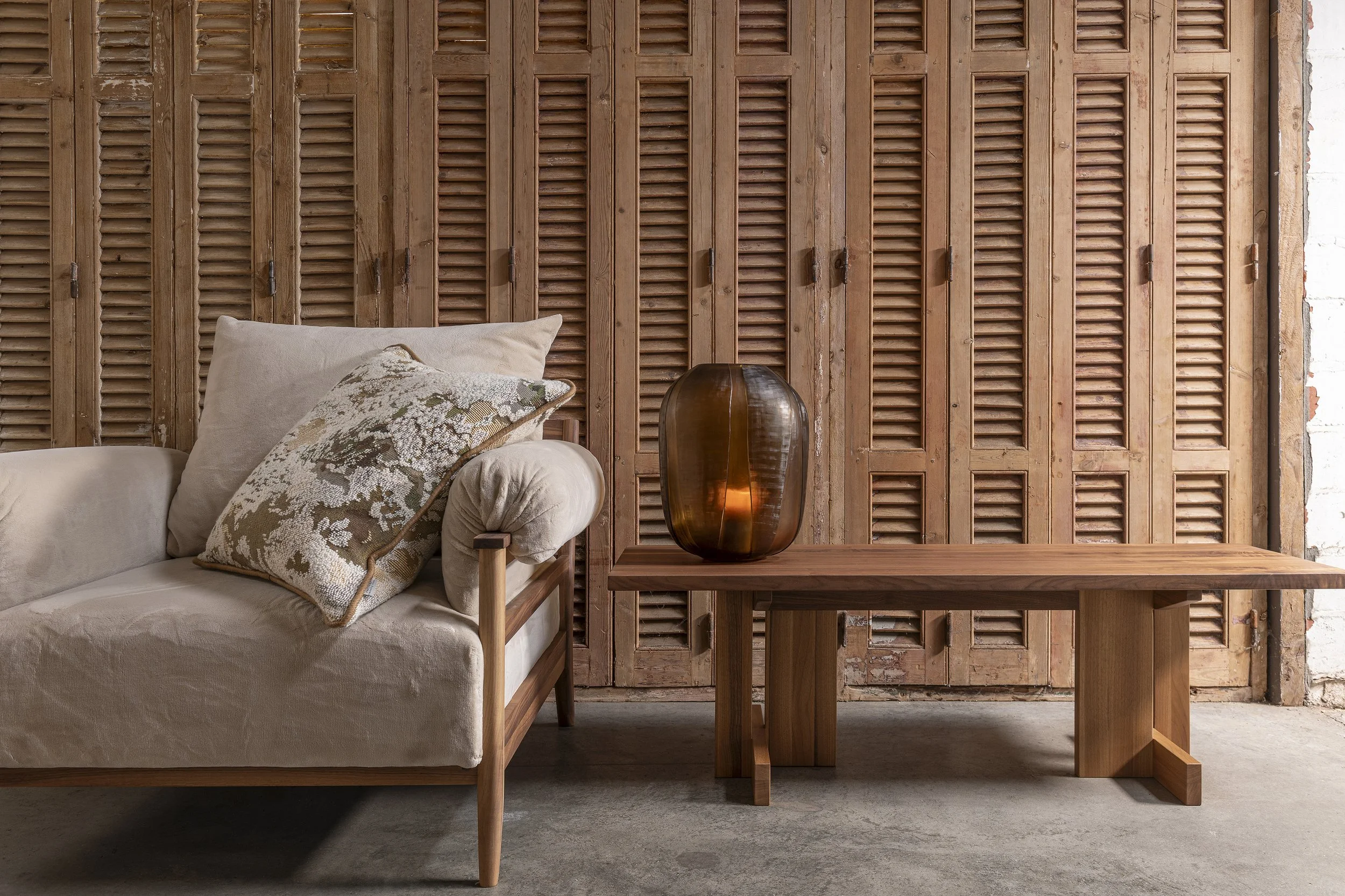 An image of a armchair in American walnut with linen upholstery..