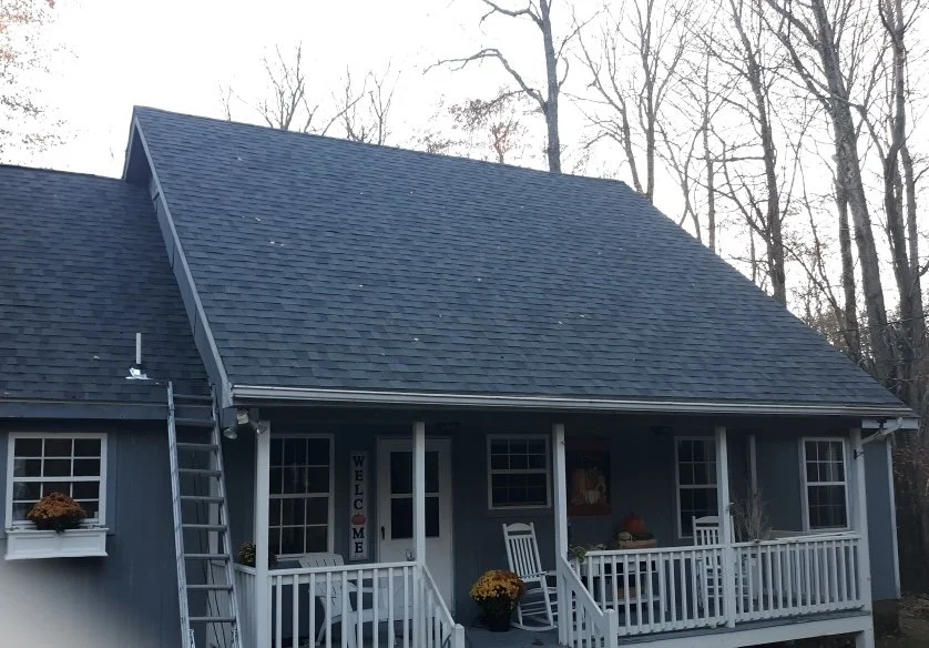 Front view of a blue house with a porch, gable roof. NEW roof in Dingmans, PA.
