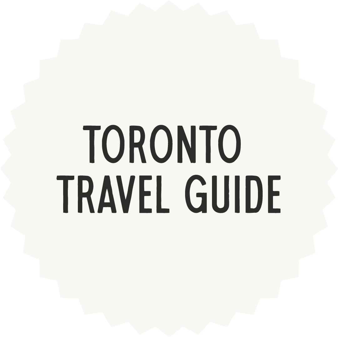A circular badge with a spiked edge that reads 'Toronto Travel Guide' in bold black letters on a white background.