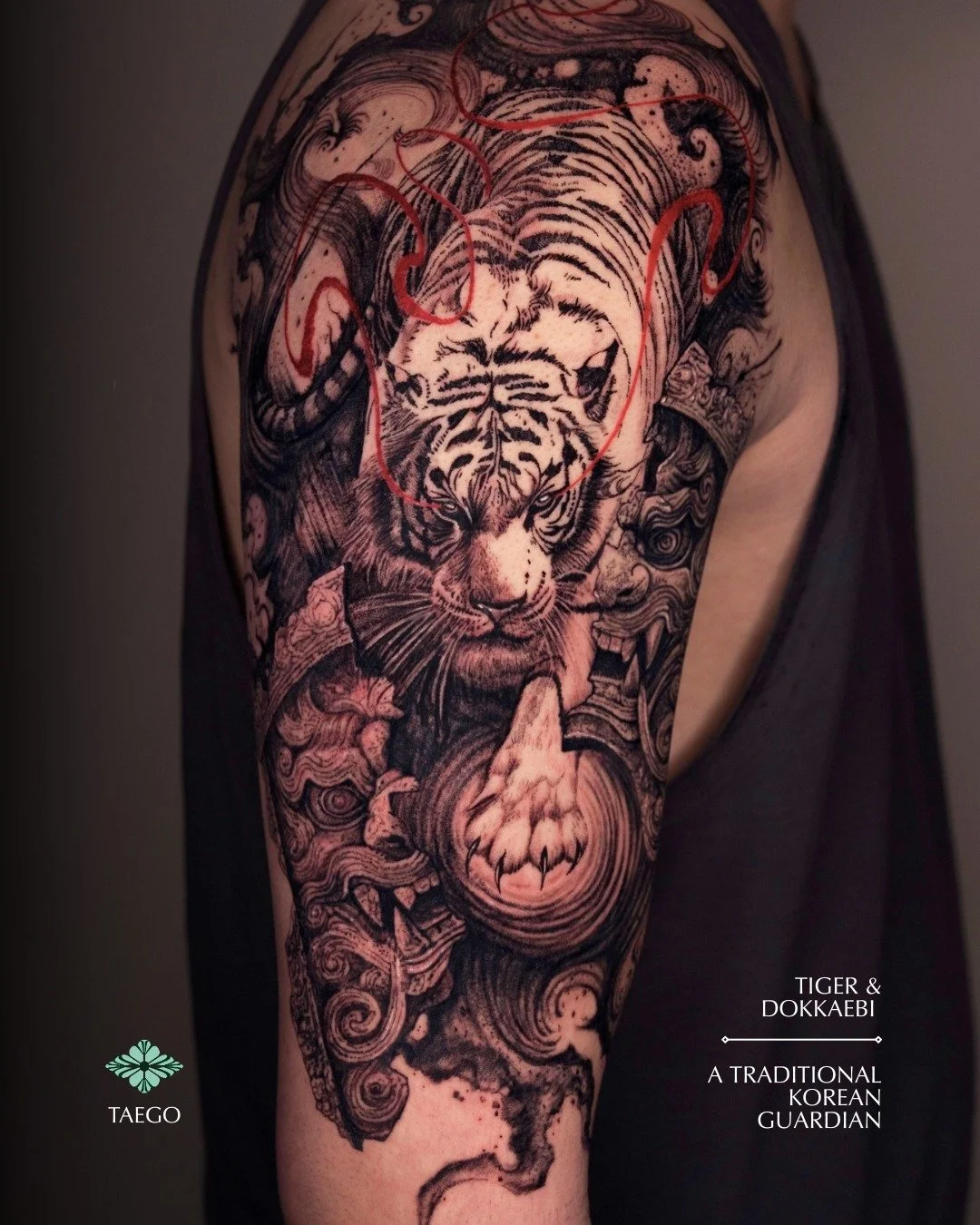 A traditional Korean guardian symbol, Gwimyeonwam, with a Dokkaebi and a tiger by @taego.ink 🔥🐯

Taego's May bookings are open -- DM him directly for bookings and inquiries.