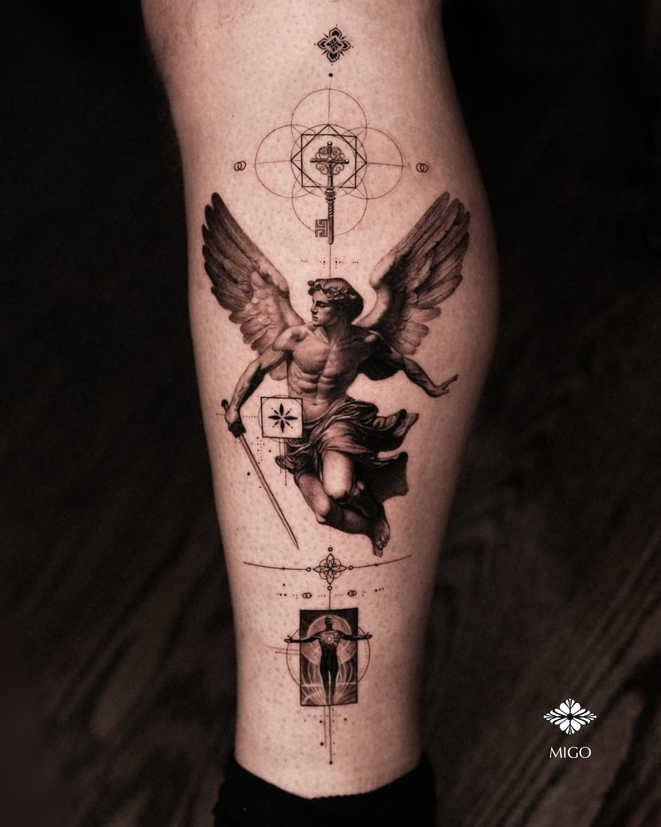 Tattoo of a winged man holding a sword, with geometric and symbolic elements above and below by Migo at Hanok Studio