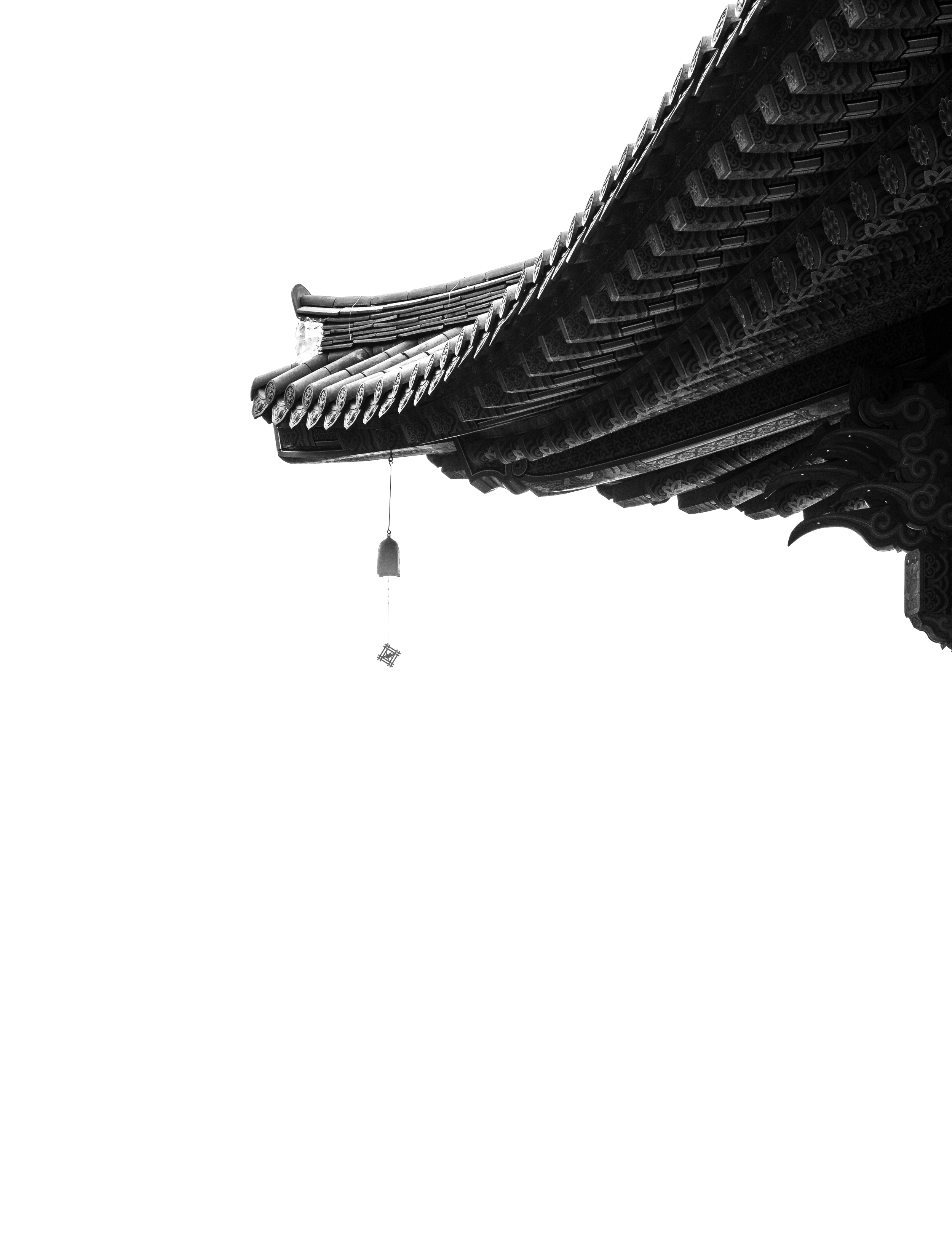 Traditional Asian temple roof with ornate details against black background