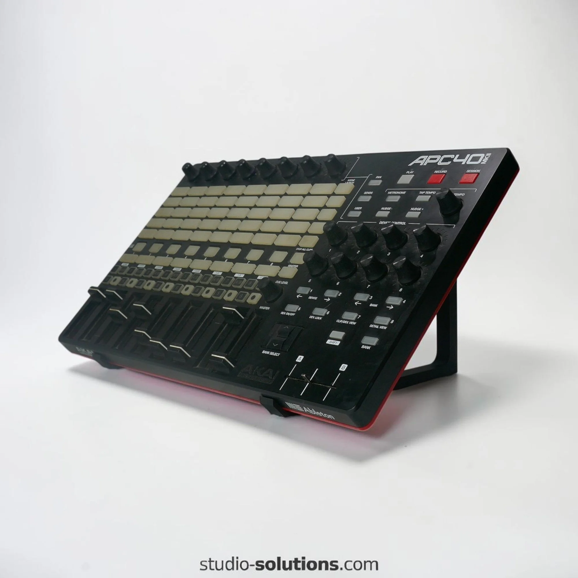 Large desktop synth stand loaded with electronic music production equipment in professional studio workflow setup