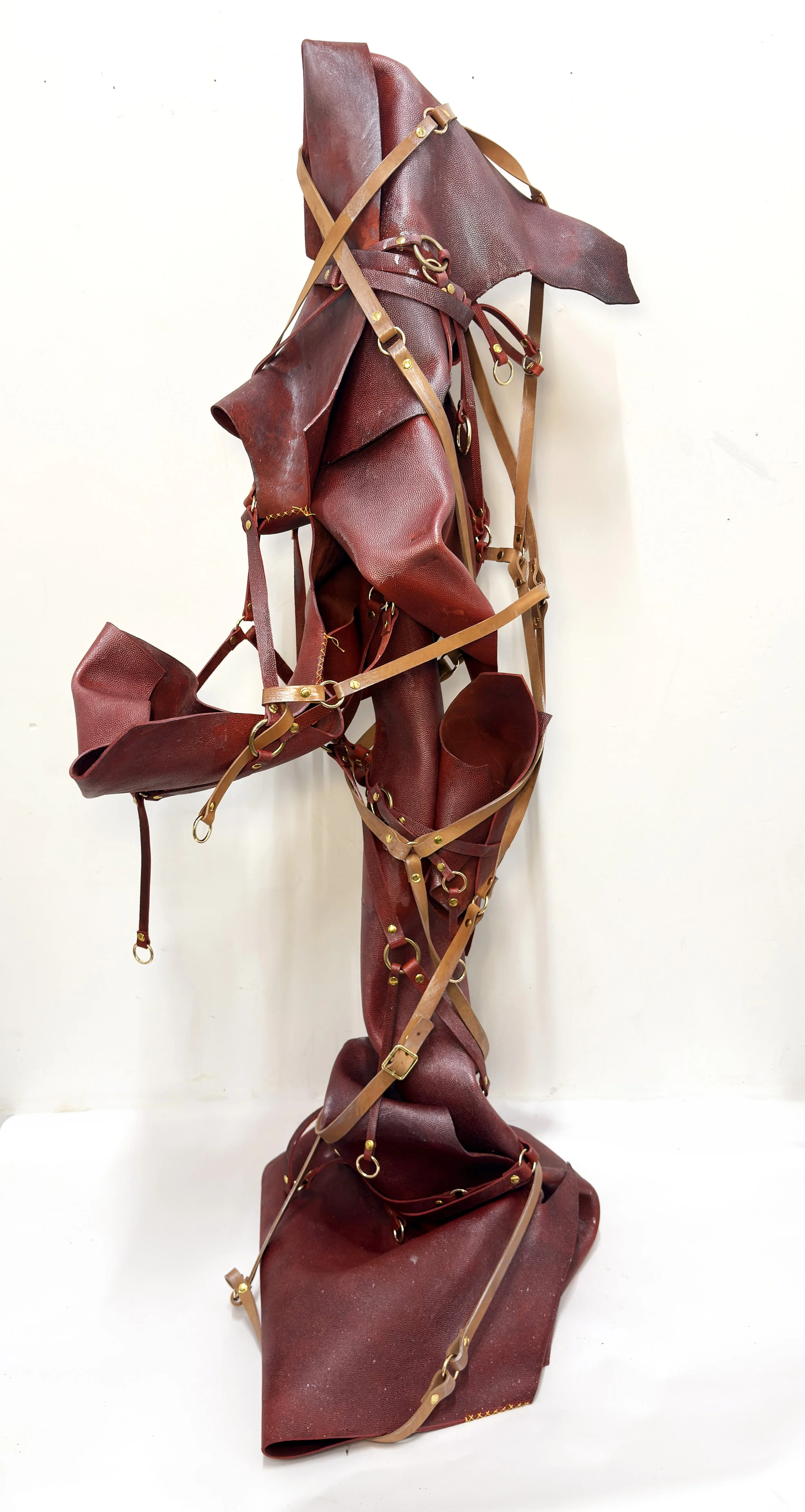 Rejected Football Goddess, 2026, Reject NFL leather from Horween, veg-tan leather,  harnesses, pigment, cross-stitch sutures, 65” x 29” x 30”
