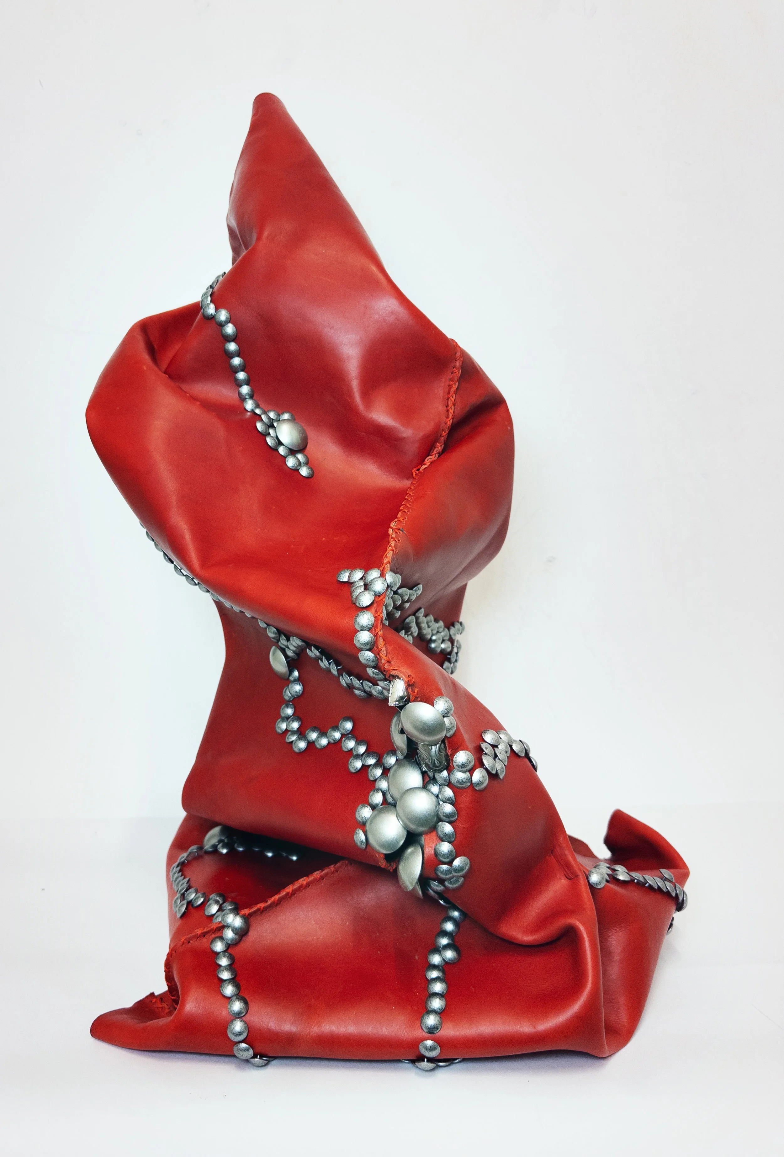 "Critical mass"

2026

Heat-soaked and molded leather, cross-stitch sutures, upholstery tacks, boot shanks

26 in x 16 in x 18 in