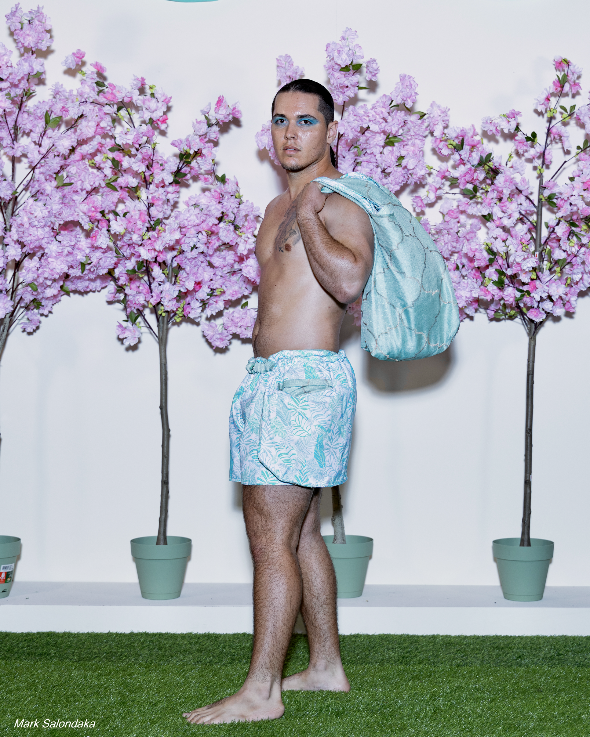 Model: Justin. Wearing: Flap Shorts with matching tote (stuffed with blanket and pillow)