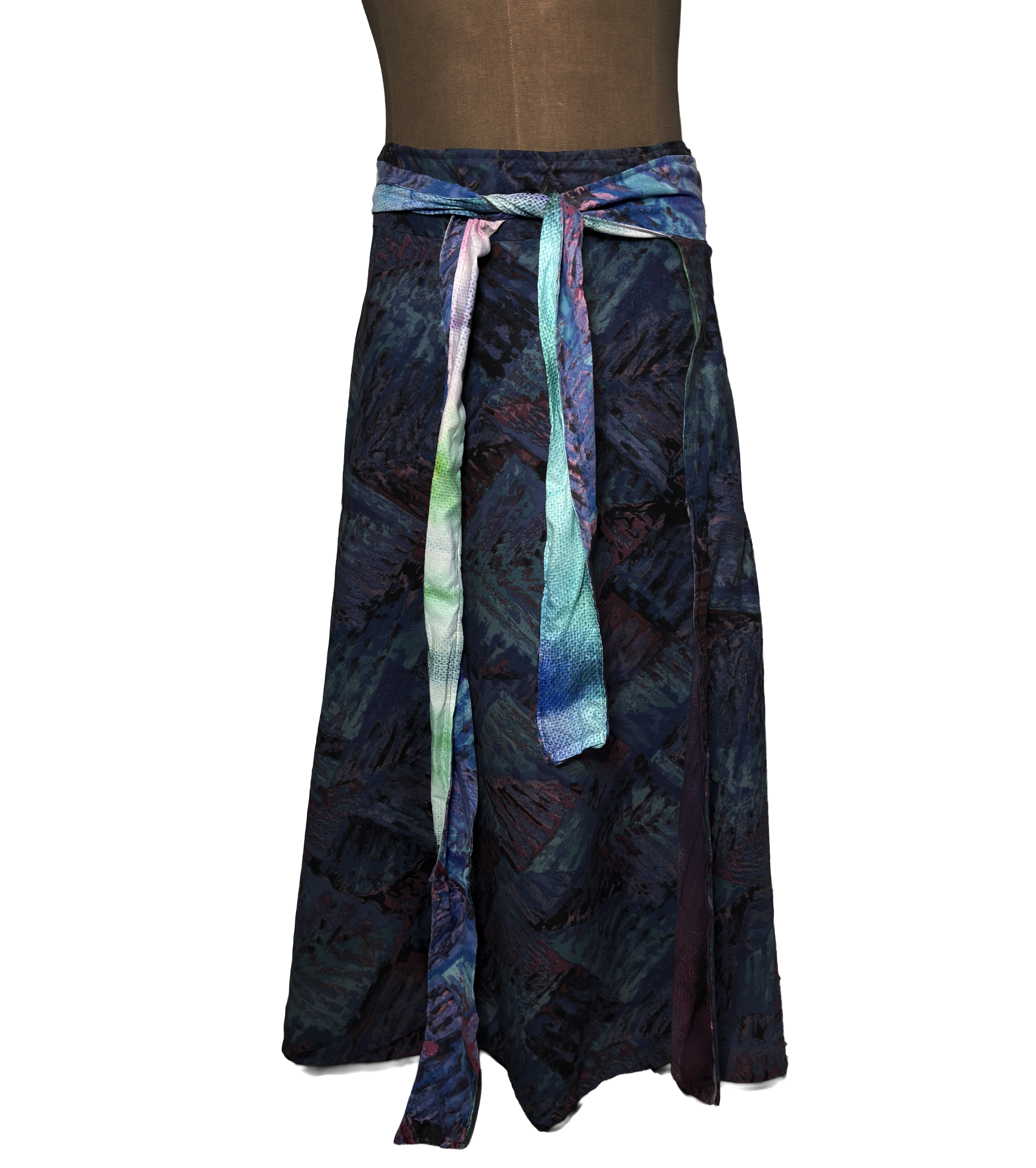 Colorful patterned fabric skirt with a tied sash on a mannequin.