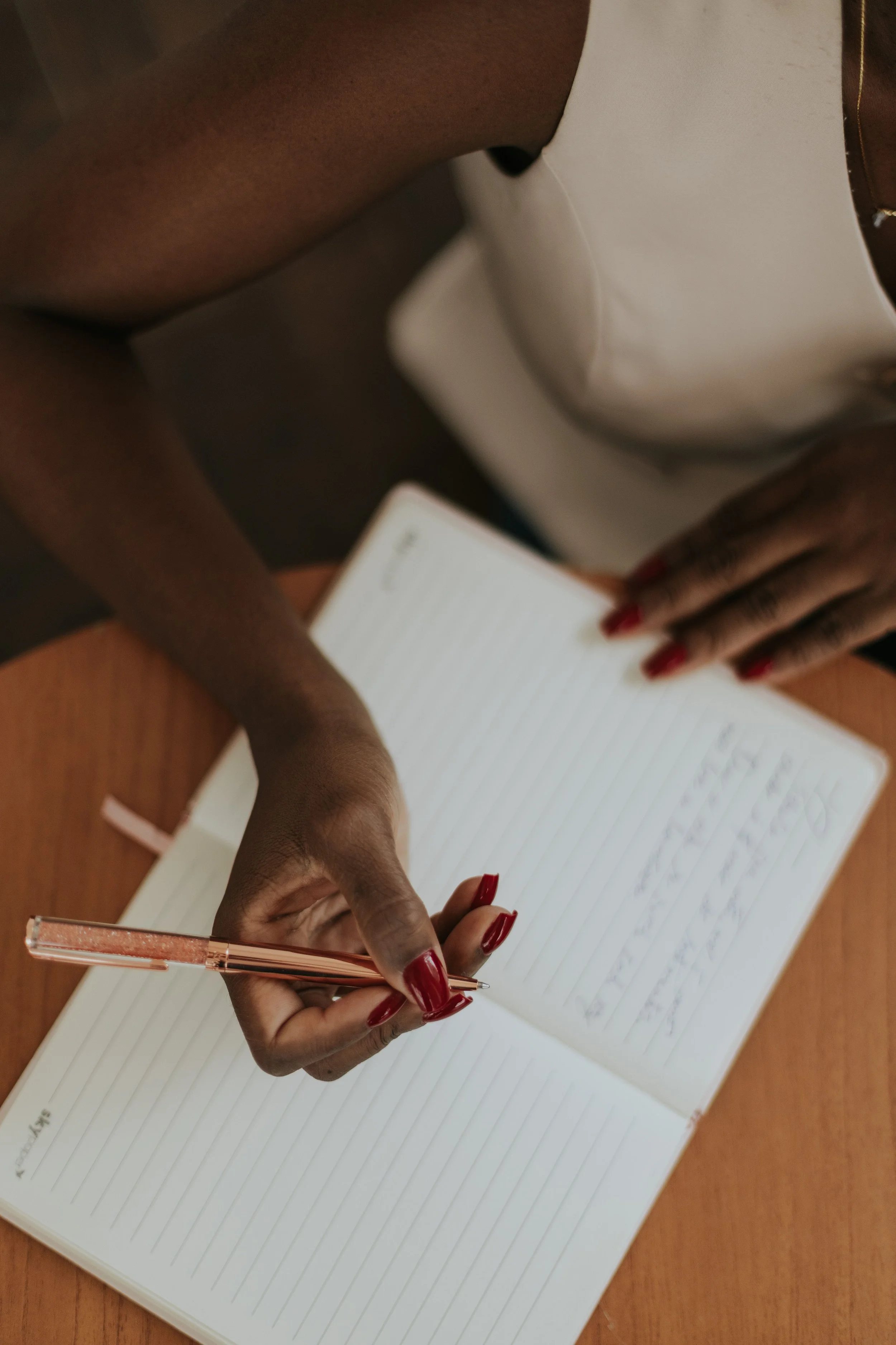 Woman writing in journal, representing the steady inner work of holding a relationship that will not be what it was.
