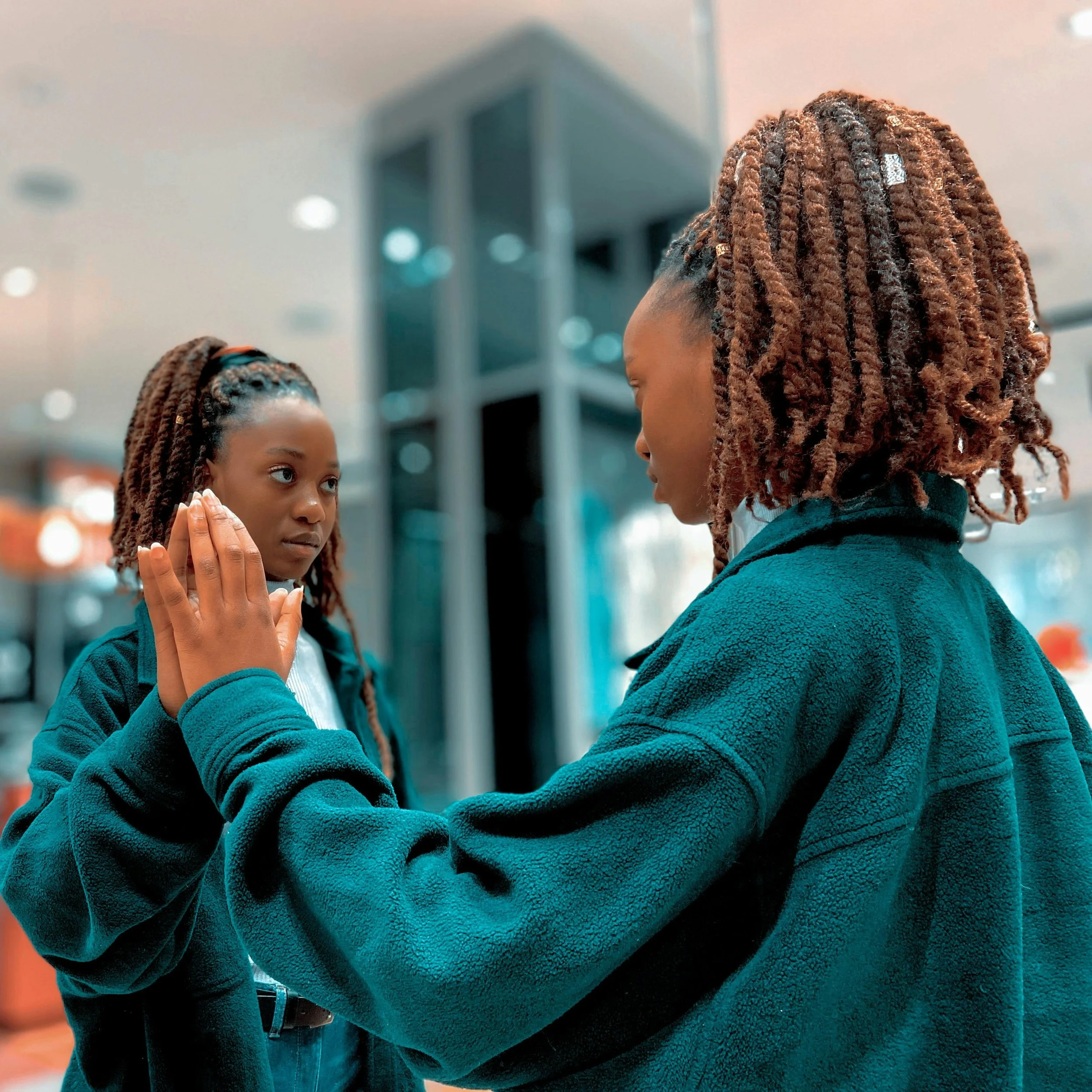 Woman looking at herself in a mirror, reflecting internal conflict between faith, self-worth, and seeking support.