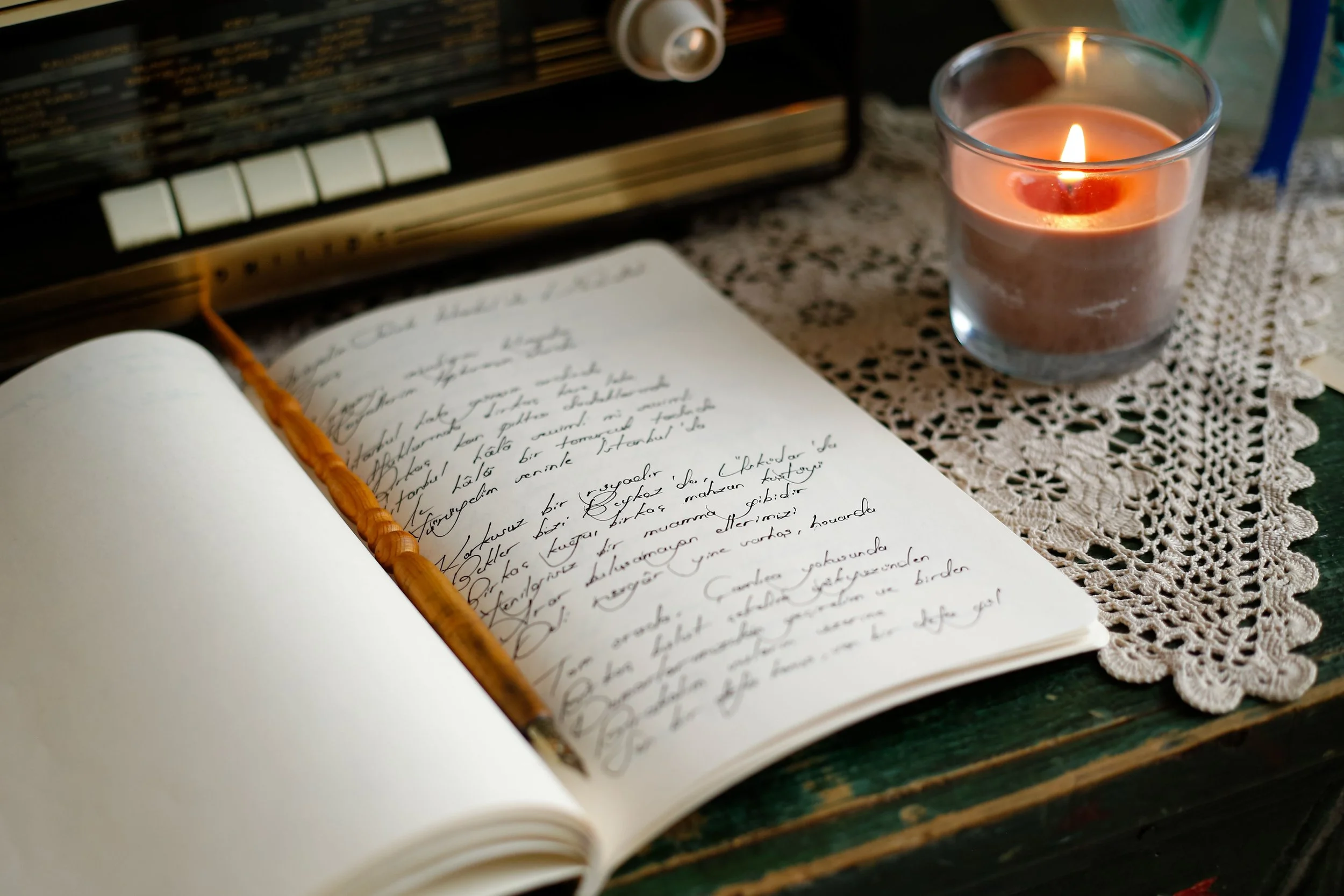 Warm handwritten journal or notebook with a pen. Suggests interior processing.