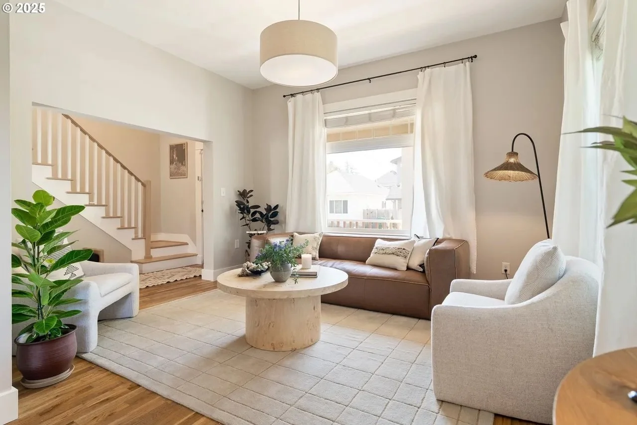 Northeast updated craftsman with hip home staging furnishings anchored by a trendy neutral rug and leather sofa