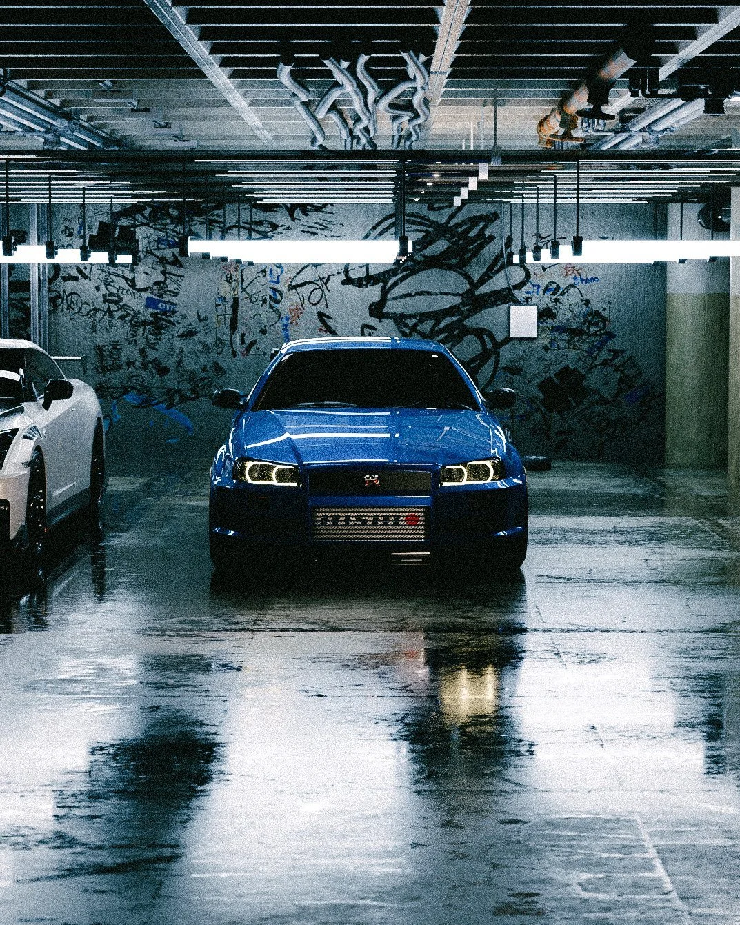Blue R34 Skyline GT-R in a wet parking garage with graffiti