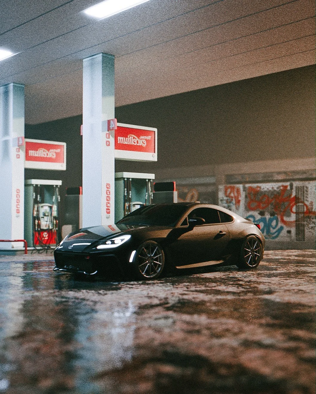 Black coupe at a gas station with graffiti on the walls