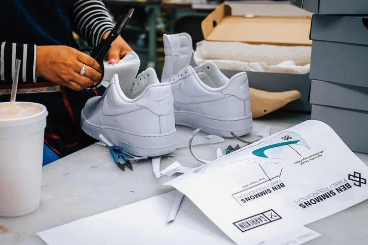 Custom Nike Air Force 1s being made at Garrixon beside Ben Simmons design sheets