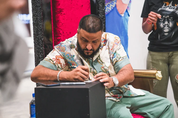 DJ Khaled signing autographs at the Snipes meet and greet, photographed by Paul Vu