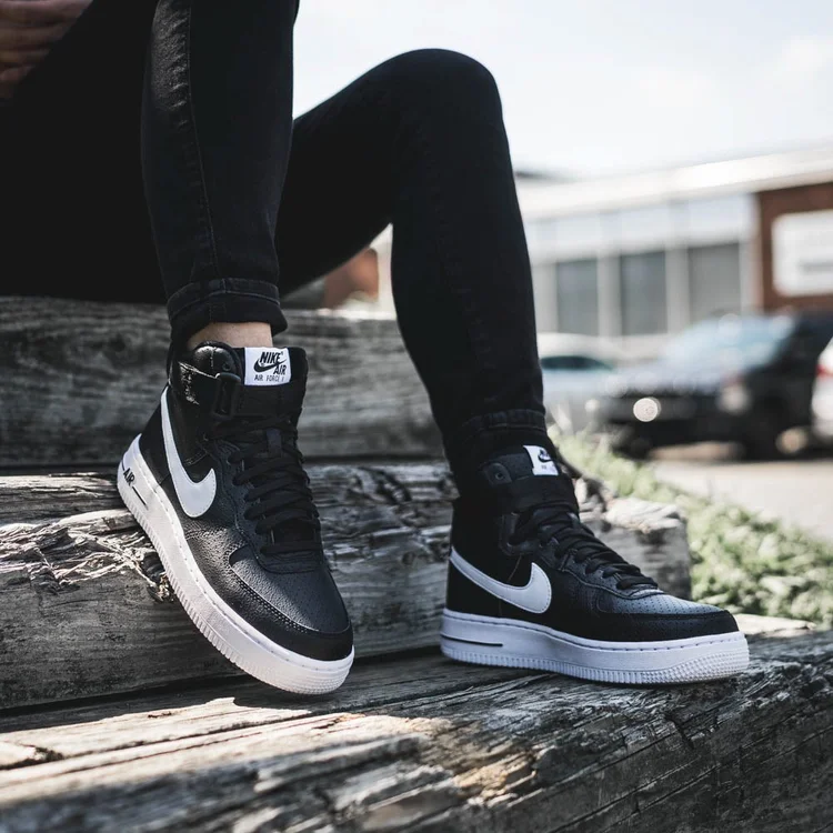 Lifestyle sneaker photo of black Nike Air Force 1s for Kicks USA