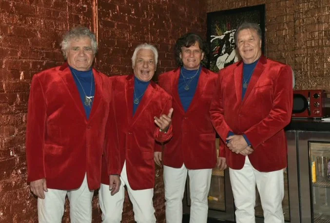 Dressed to impress and ready to perform—Jay and the Americans are bringing the heat in red!