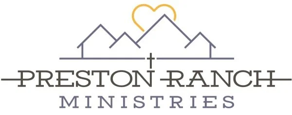 Logo for Preston Ranch Ministries featuring stylized mountain peaks, a heart, and a cross.