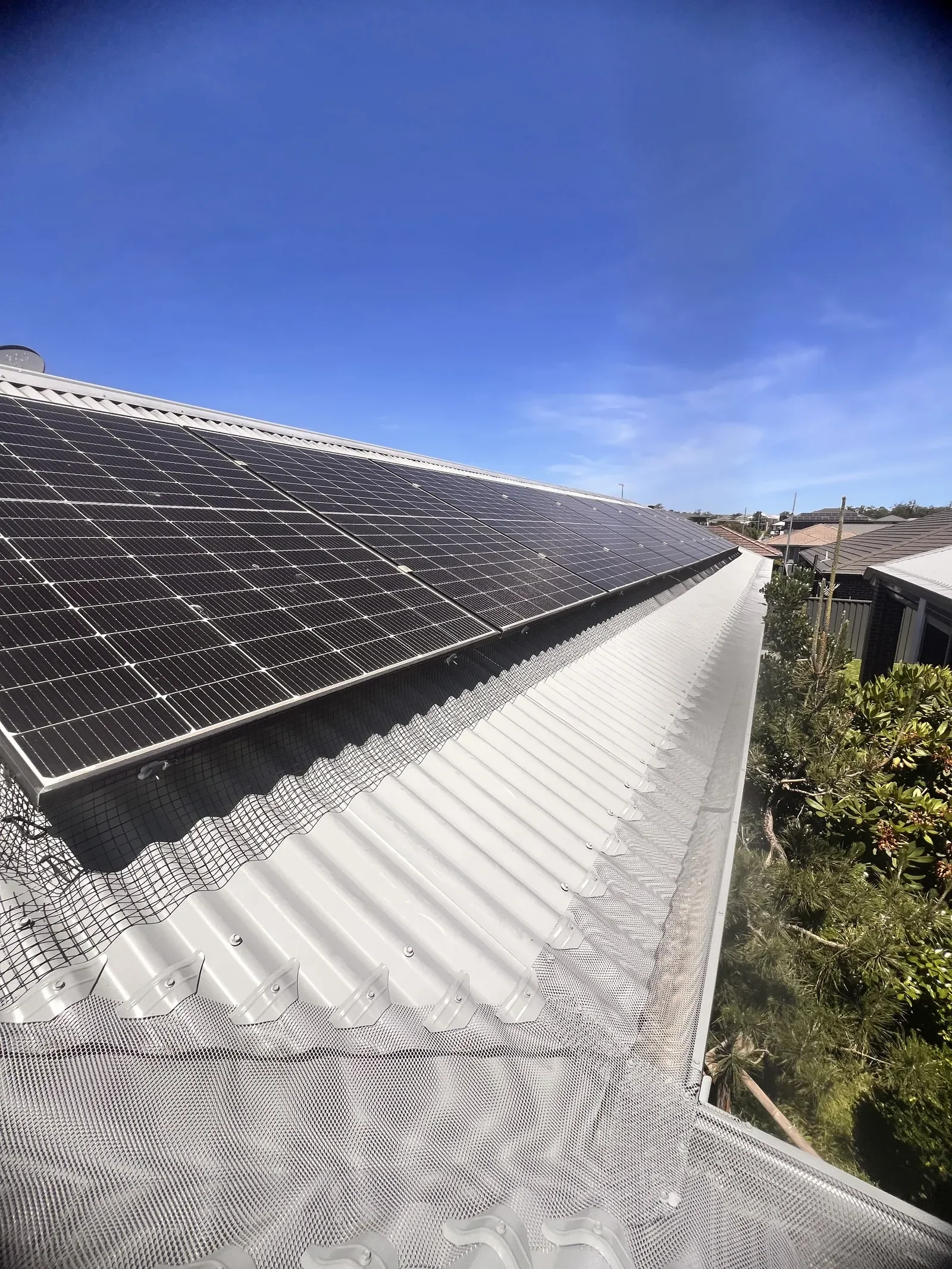 Solar panel mesh an d gutter guard installed on a metal roof in wollongong