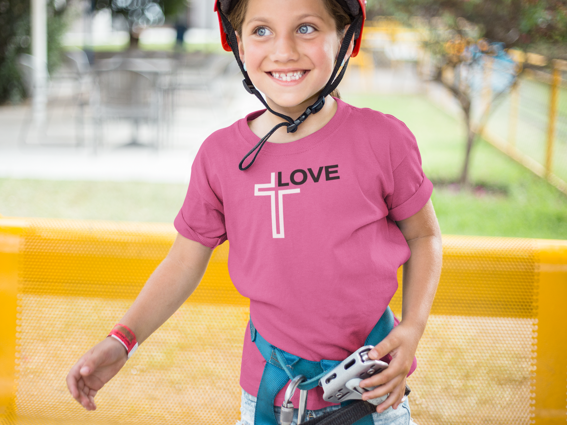 smiling-girl-wearing-a-t-shirt-mockup-while-wearing-a-red-helmet-a16163.png