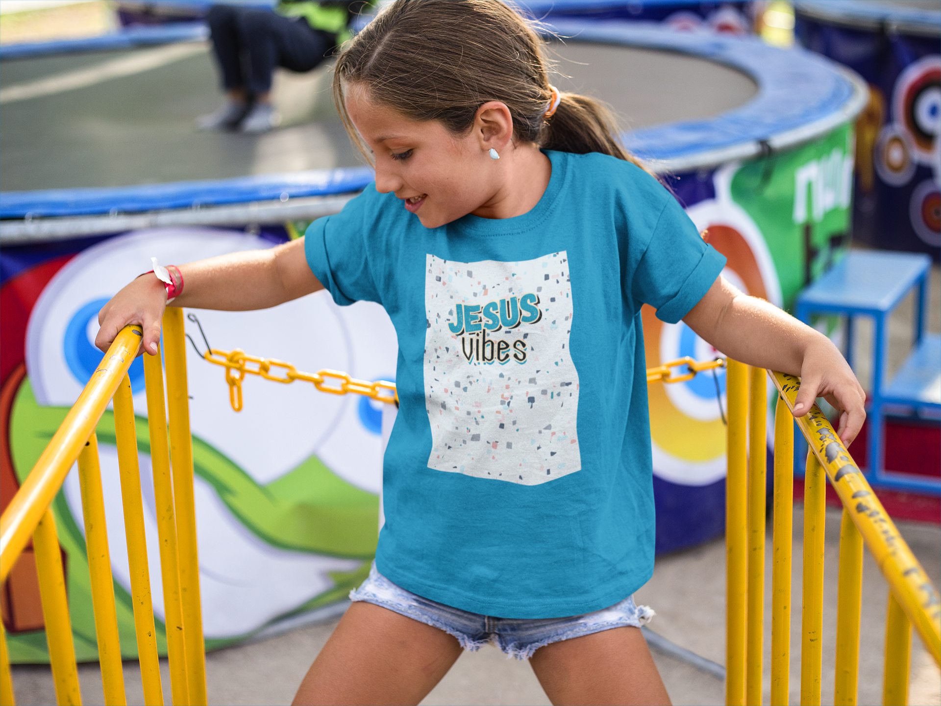 little-girl-wearing-a-round-neck-tee-mockup-while-at-a-yellow-railing-a16169.png
