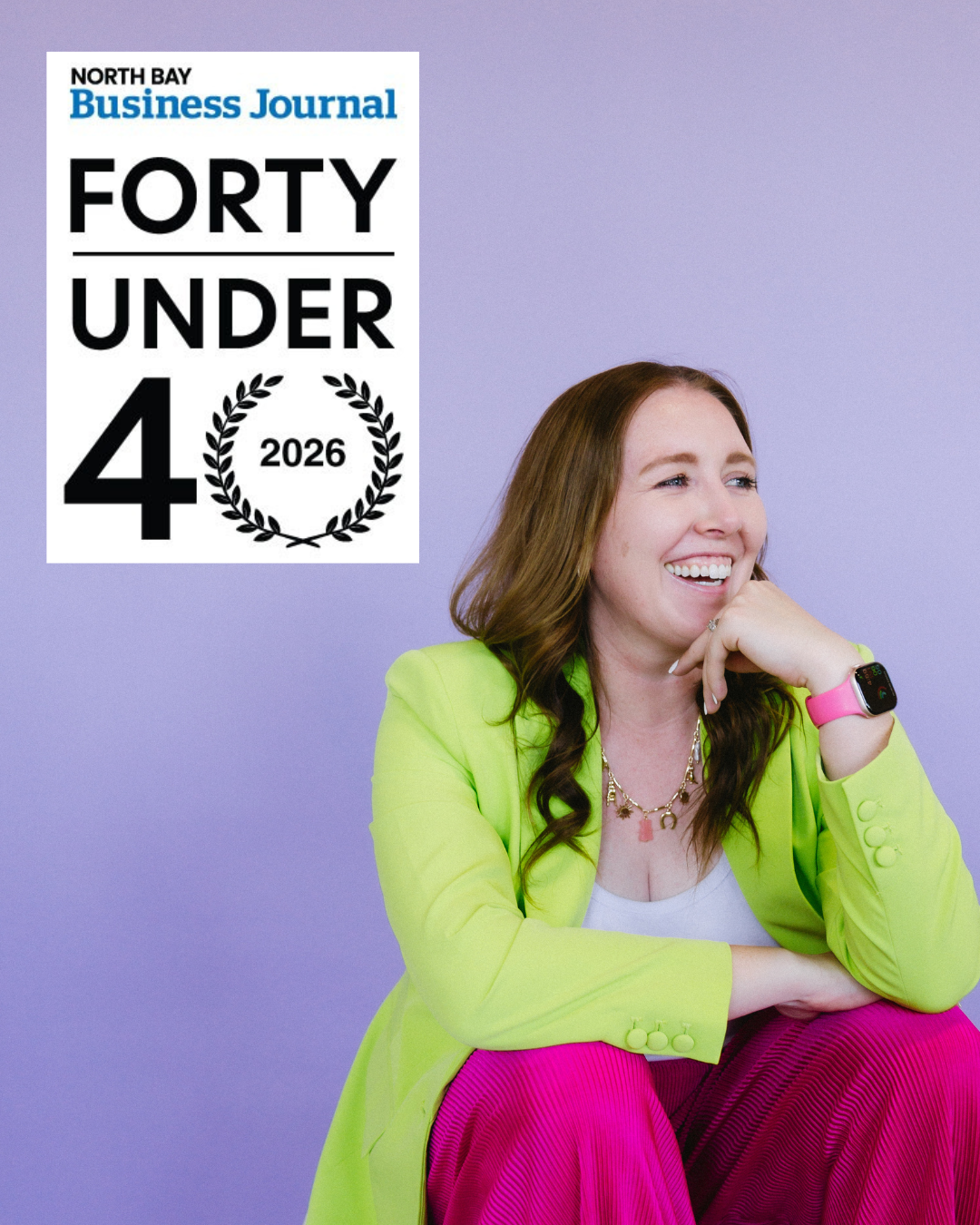 Women smiling, seated against a light purple background, wearing a bright yellow blazer, pink pants, and a smartwatch, with a North Bay Business Journal magazine cover in the upper left corner titled "Forty Under 4 2026".