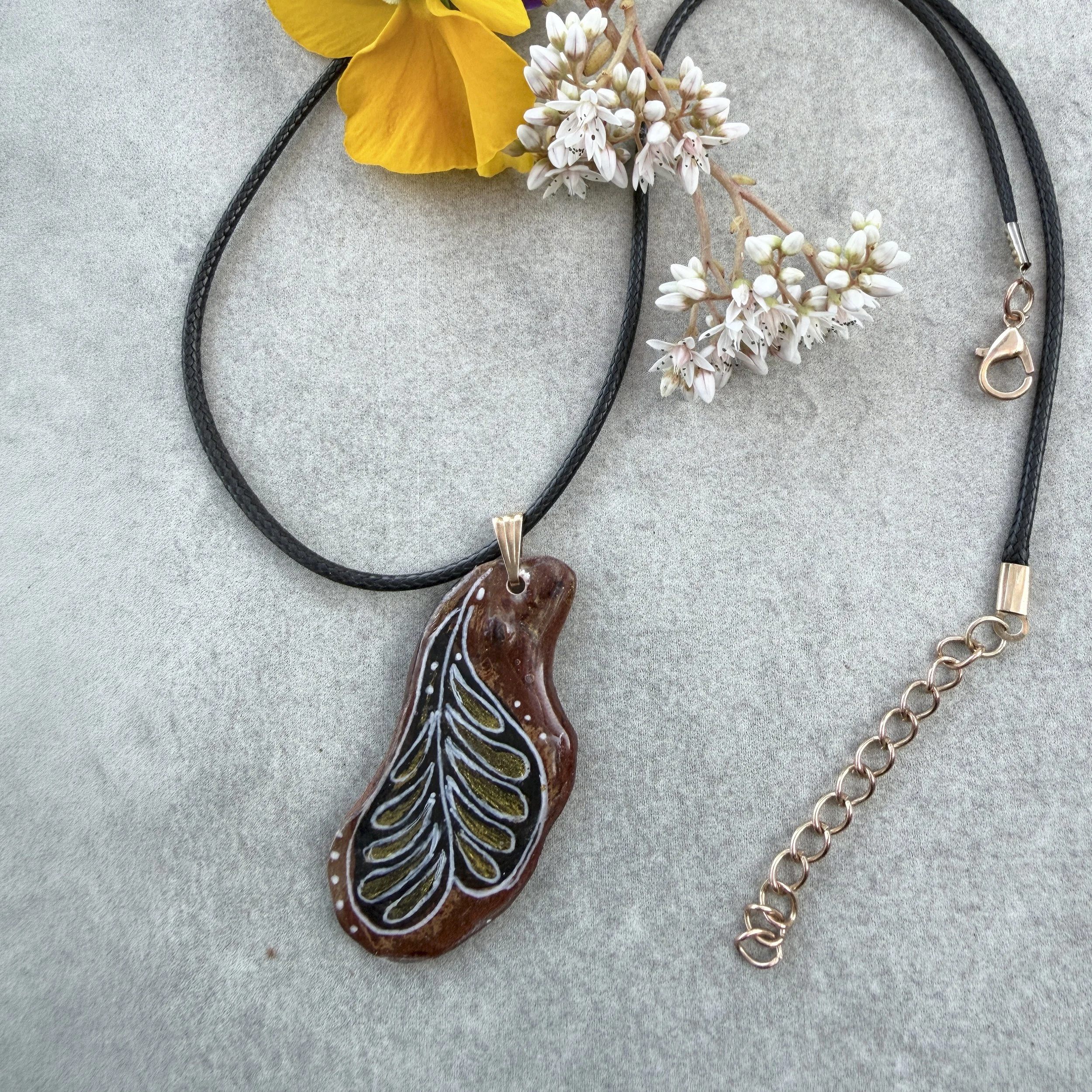 'Plume' one-of-a-kind bark pendant — hand-painted gold and white feather motif on deep black, on waxed leather cord with gold extender chain, Crimean pine bark