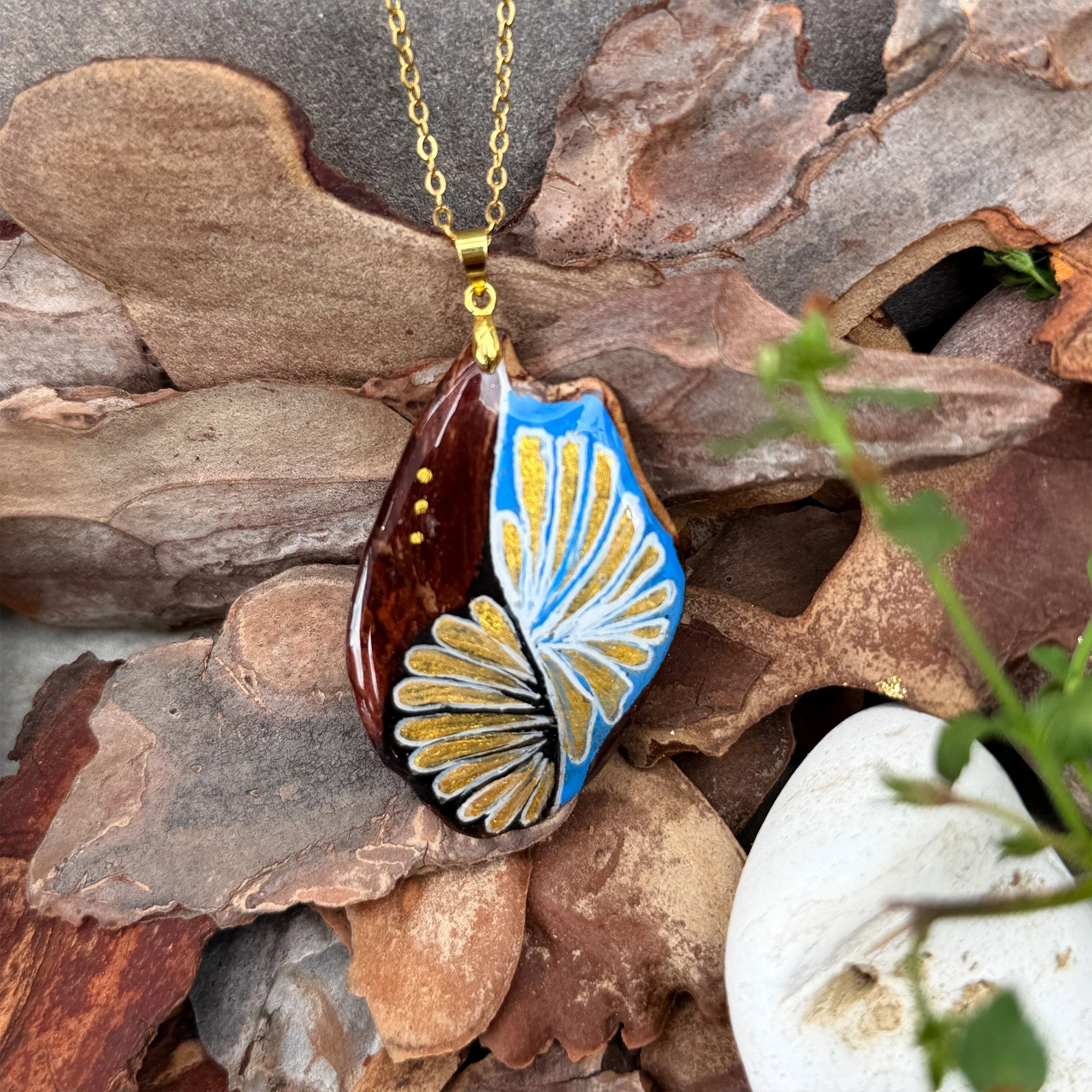 One-of-a-kind bark pendant necklace displayed on natural bark background