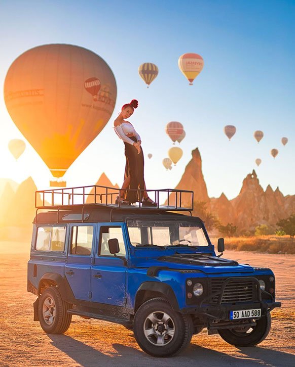 Open-top Jeep driving through the rugged valleys and rock formations of Cappadocia, offering a thrilling off-road adventure amidst the region’s stunning landscapes.