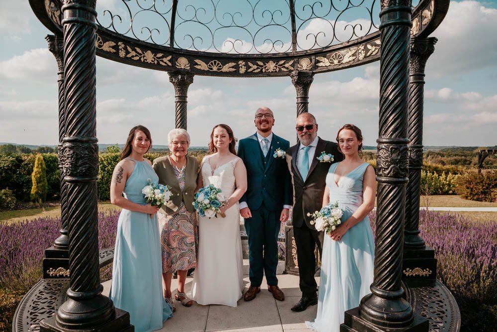 happy couple with bride's family in lavender garden