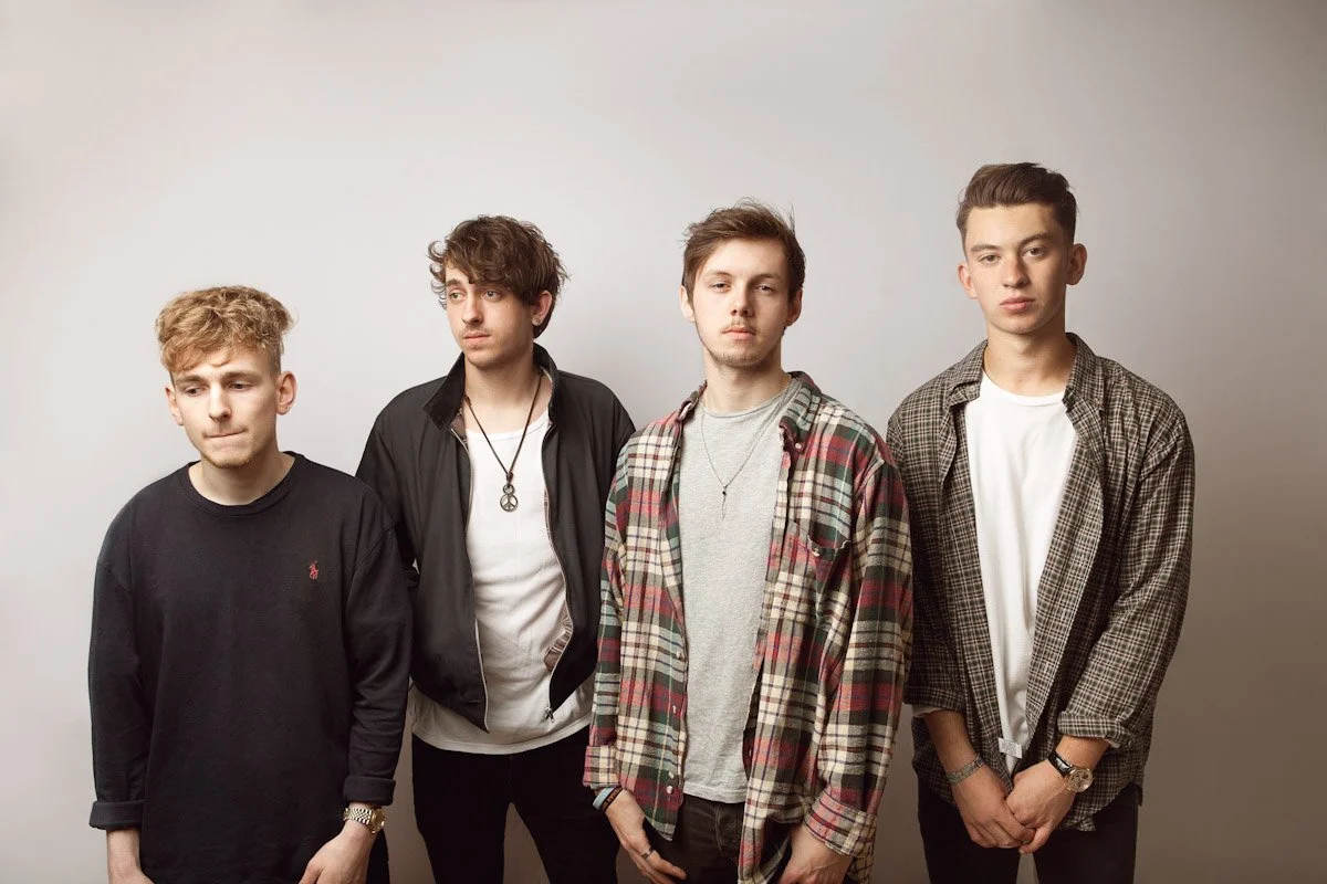 Band photoshoot in front of a plain white background