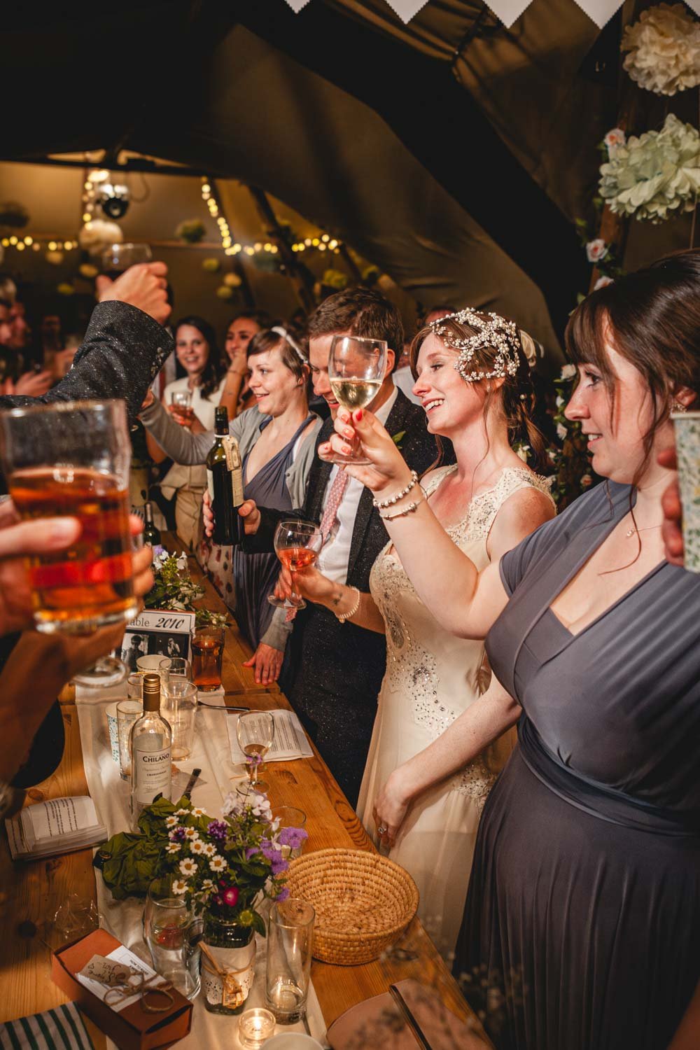 guests raise glasses in toast to the happy couple