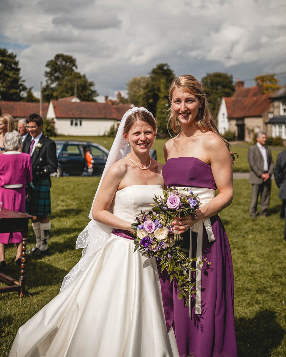 bride poses with bridesmaid in oxfordshire