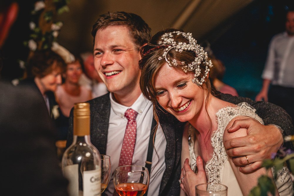 bride and groom hug during wedding speeches