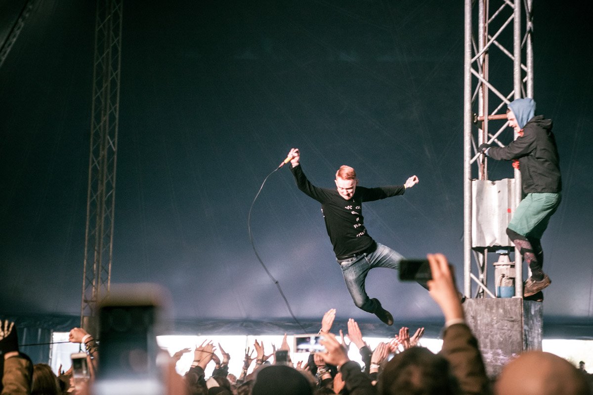 Frank Carter jumps from a pillar into the crowd at Groezrock festival in Belgium