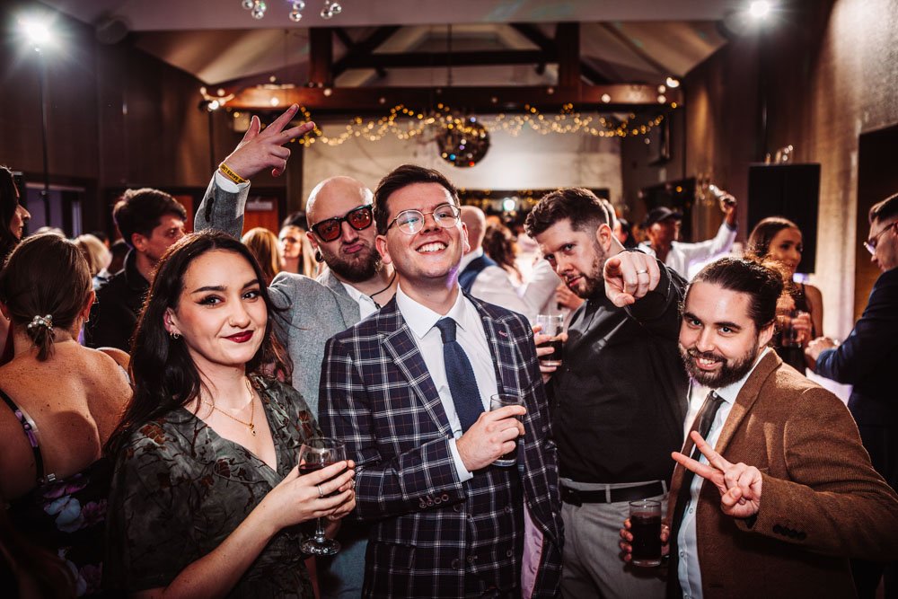 guests pose on the dance floor at Goosedale wedding